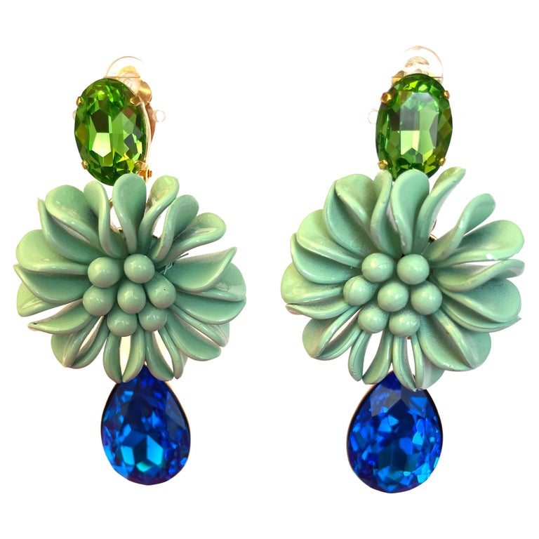Statement earrings with Swarovski crystals and molded resin flower in aqua.
Philippe Ferrandis, French luxury designer. His jewels are hand-made in his workshops in Paris, in the respect of an exceptional know-how.
He has been a parurier in Paris