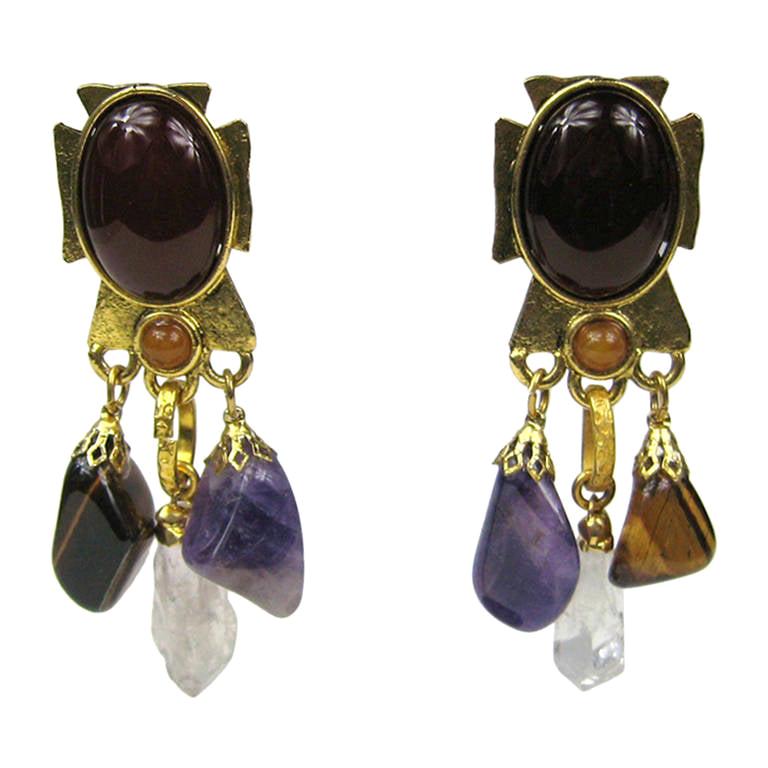 Philippe Ferrandis Stone Bronze Amethyst Quartz and Tigers eye Earrings Clip on's. Measure 3.22 inches Long x 1 inches wide as it sits on your ear. Cross-shaped on the metal earring, with an amber-colored Stone center. Truly a work of art, Circa