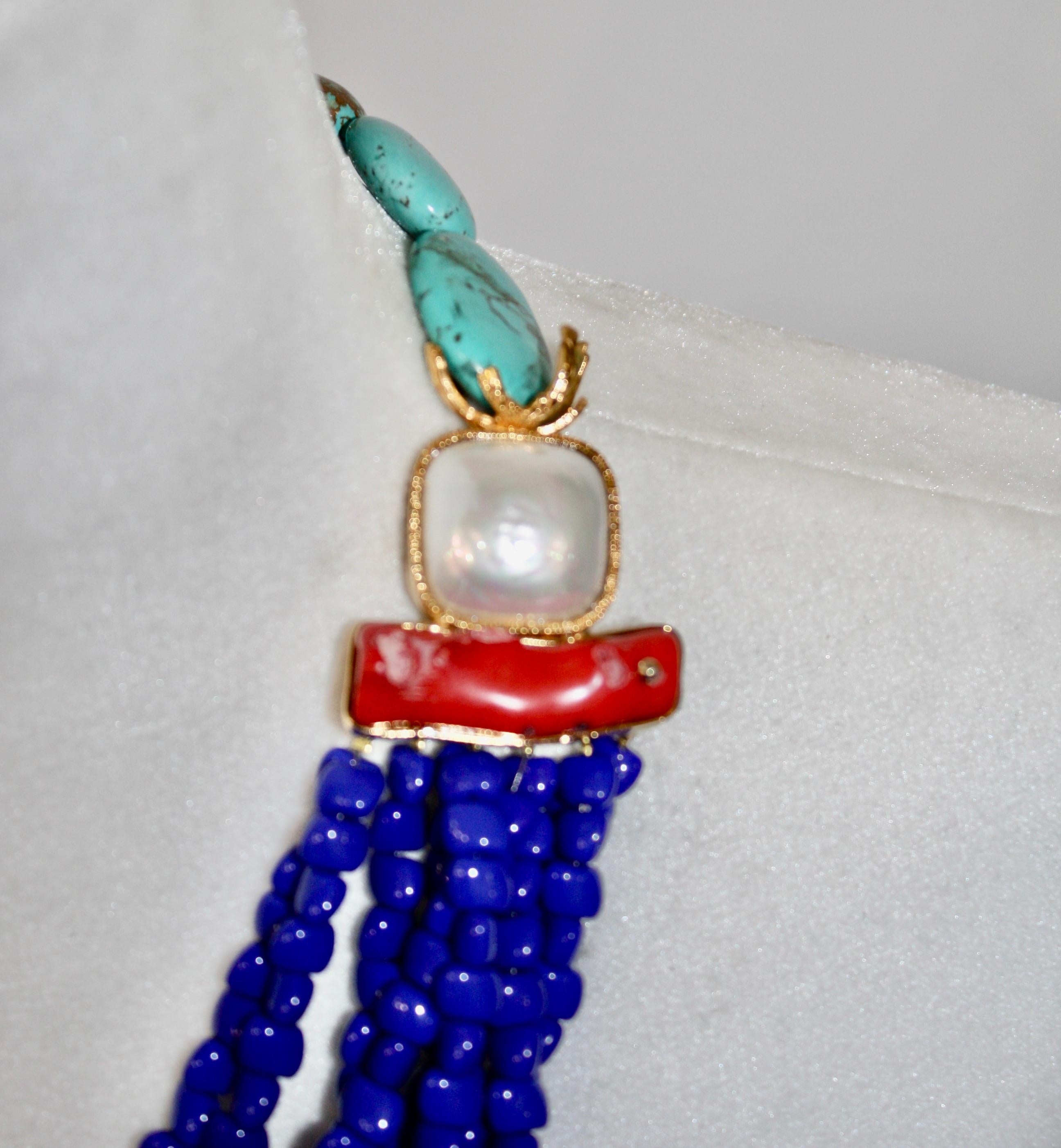 From Philippe Ferrandis collection, this choker is composed of turquoise, coral, blue agate and handmade pearl cabochons. Gilded brass. Clasp with chain and hook for adjustable length. Signature on the back. 4” extension chain.
Exclusively for