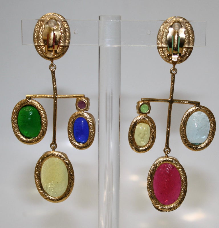 Asymmetric earrings made  in 24-carat gilded brass metal. Pate de verre or poured glass created in the process created by the House of Gripoix.
Vivid colors for the season.