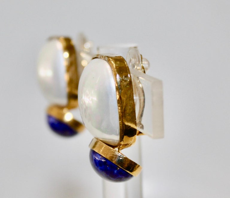 Earrings like a mother-of-pearl button with a lapis lazuli cabochon.