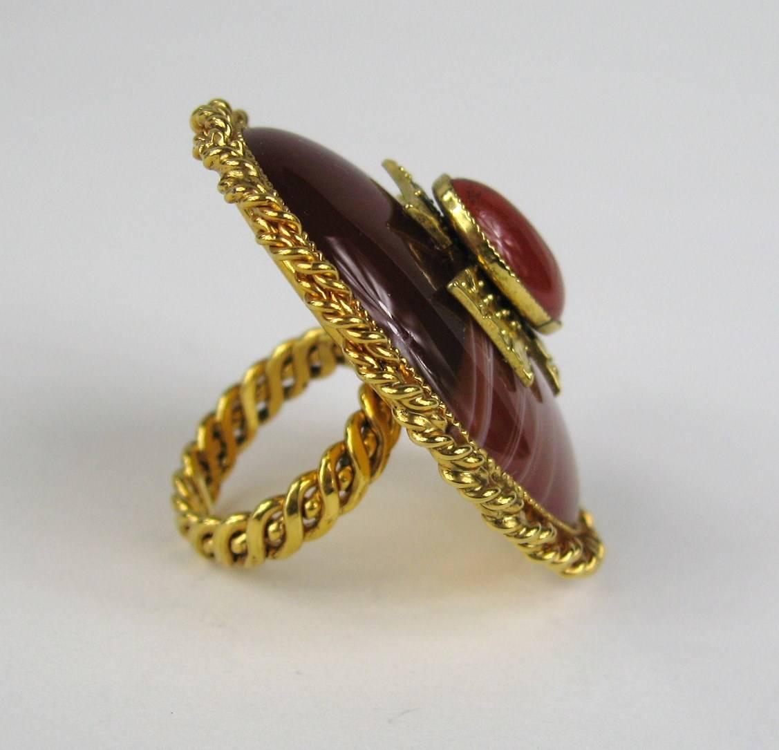 Large Philippe Ferrandis Ring. Oval Gold Gilt Braided motif surrounding a gripoix poured glass center. A Top is a Maltese Cross set in gripoix. This is is a large ring. Measuring 1.83 inches x 1.47 inches wide. The ring is a size 6.5. This is out of