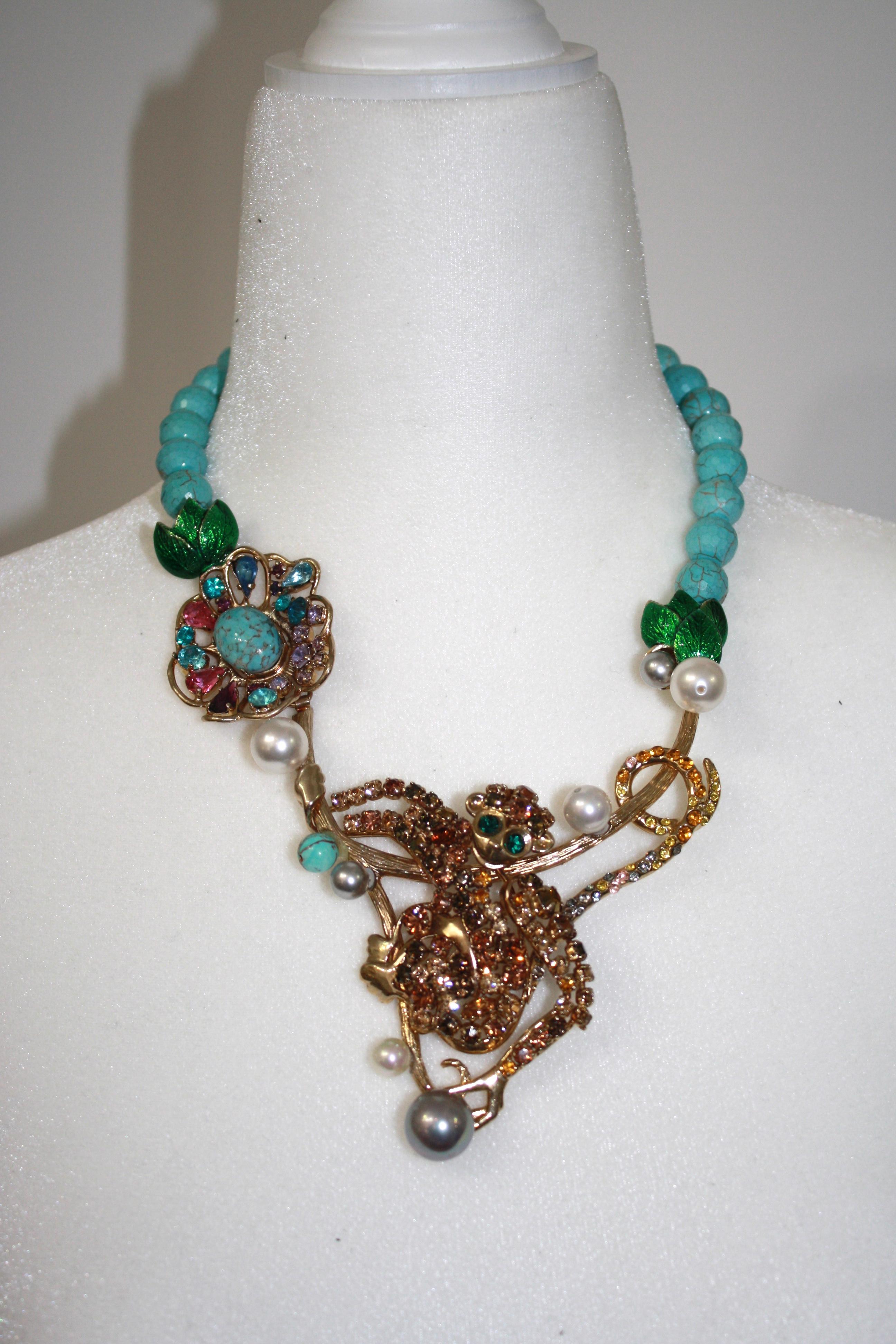 One of a kind necklace, a monkey with an articulated arm on gilded brass encrusted with Swarovski crystals. Turquoise beads and hand painted enamel motifs. 3