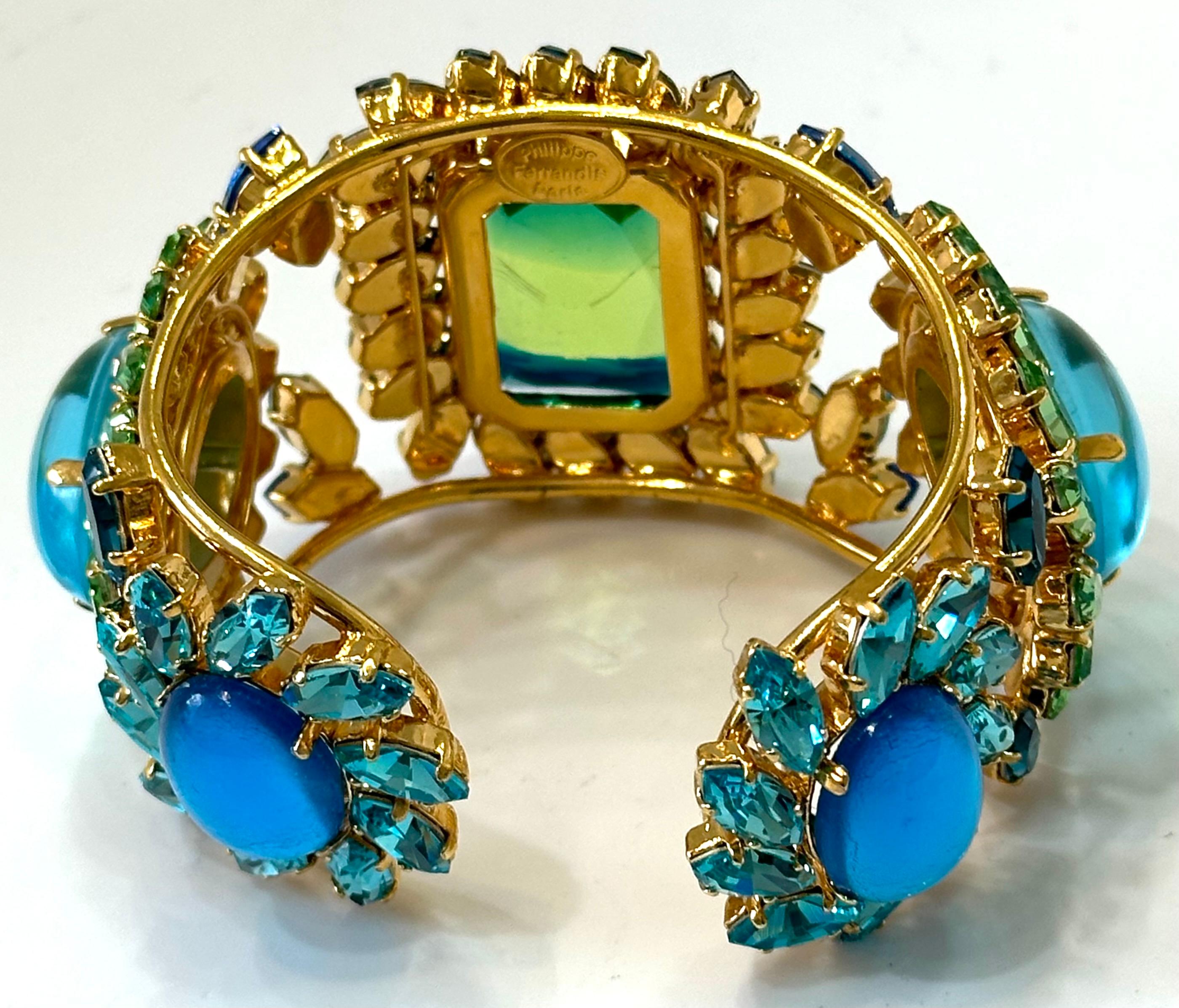 One a kind cuff made exclusively for Isabelle K Jewelry.
24carat gilded brass, Swarovski Crytal in exquisite colors. Handmade glass cabochons. Bracelets is very flexible and can fit most size wrist 
One of a kind made exclusively for Isabelle K