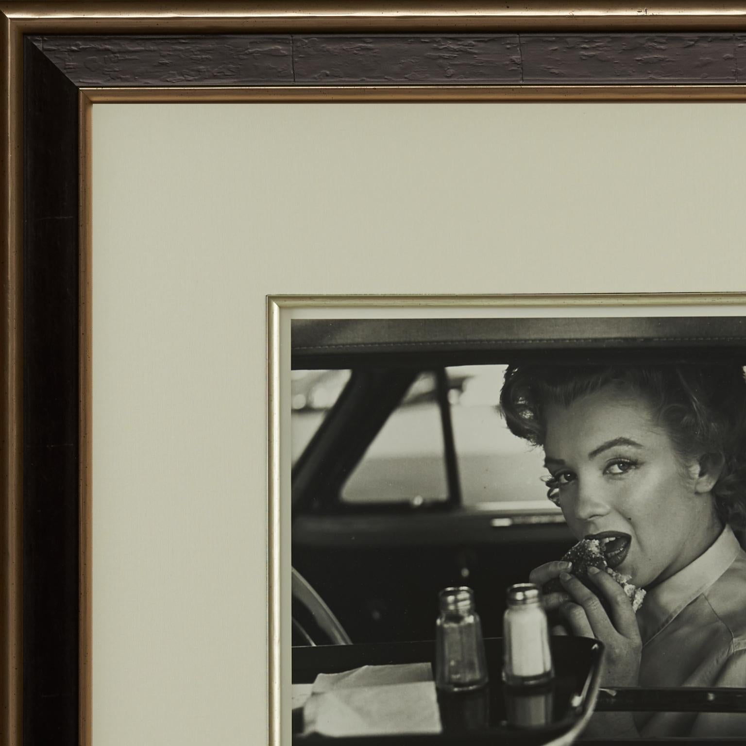 This charming silver gelatin print of Marilyn eating a burger at the drive-in was created by photoographer, Philippe Halsman, in 1952, and printed under license by his estate in 1981, two years after his death.

This dazzling special edition print,