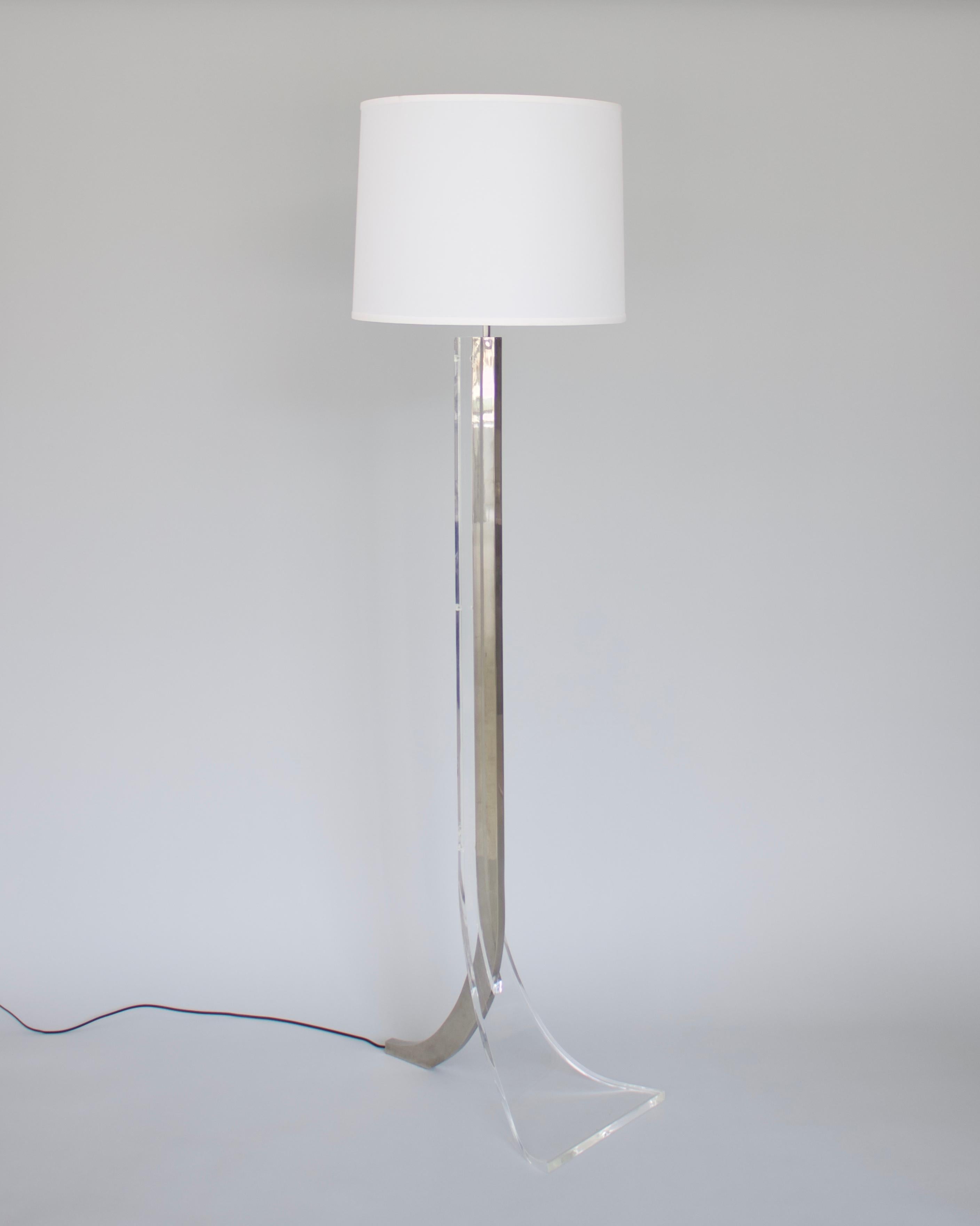 Philippe Jean lucite and polished nickel chrome floor lamp with organic flowing foot in a circa 1970 motif. 
The nickel chrome has been repolished and also the lucite. The lucite has a few spots of some internal spiderwebbing indicative of age.