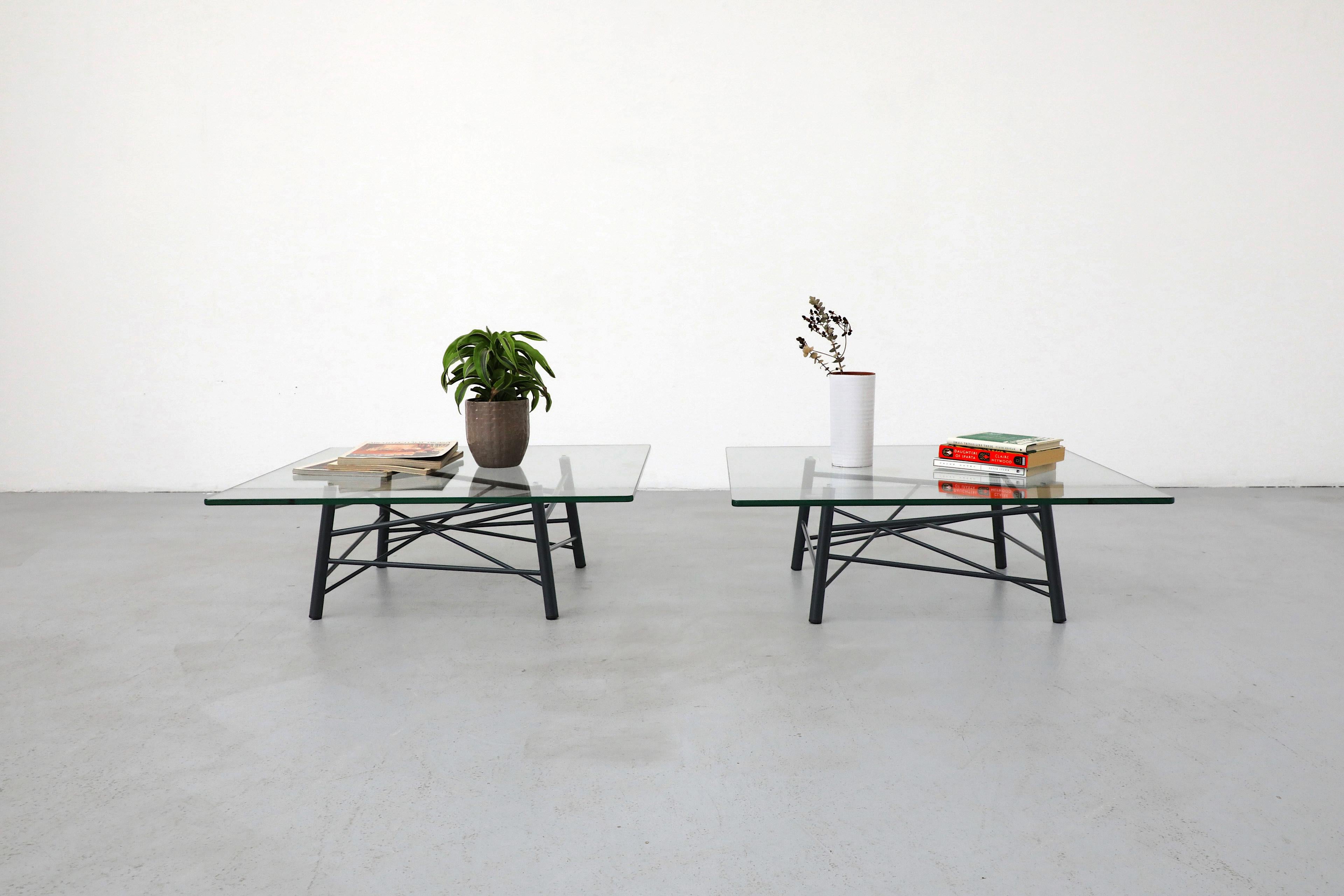 Philippe Nigro designed Triangolazione square side or coffee tables for the Italian company Skitch, 2009. These modern, attractive tables feature a gray metal tubular base with dynamic intersecting lines and rounded corner square plate glass tops.