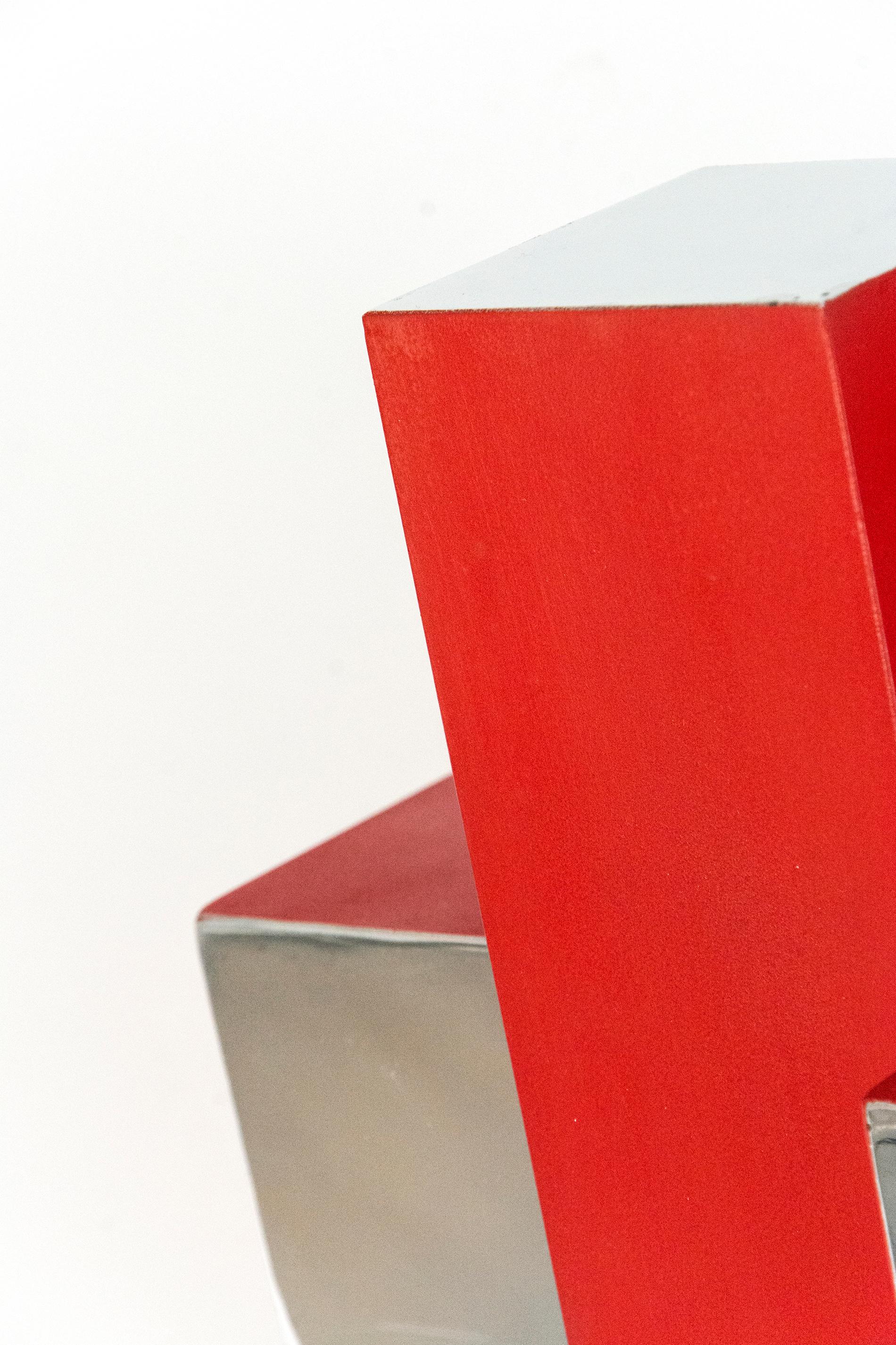 Intersecting geometry in poppy red and polished aluminum form a dynamic whole in this modern sculpture by Philippe Pallafray. This work is number 1 in an edition of 10.

Philippe Pallafray (b. 1965, France) is a member of the Sculptors Society of