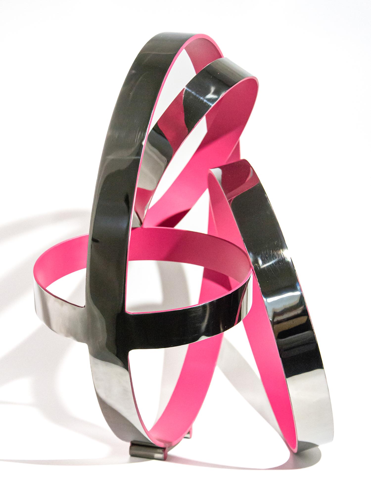 Hot pink pops from the interior of four intersecting polished stainless-steel rings in this contemporary tabletop sculpture by Quebec artist Philippe Pallafray. His elegant abstract work is designed to represent the duality of nature and the