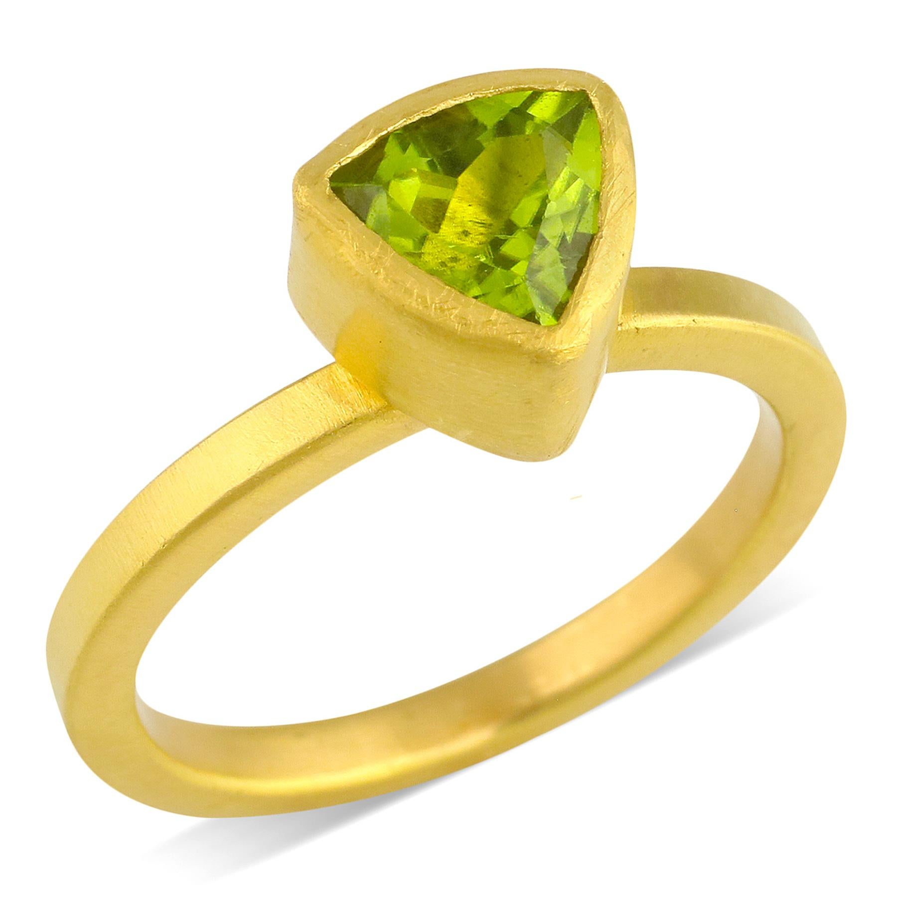 PHILIPPE-SPENCER -   1.4 Ct. Faceted Trillion Peridot wrapped in 22K Gold Bezel Setting, with Anvil-Forged Solid 20K Gold 2.25mm x 2mm Band. Heavy Brushed Exterior, Mirror Polish Interior.  Size 7, and is in-stock and ready to ship. Our apologies in