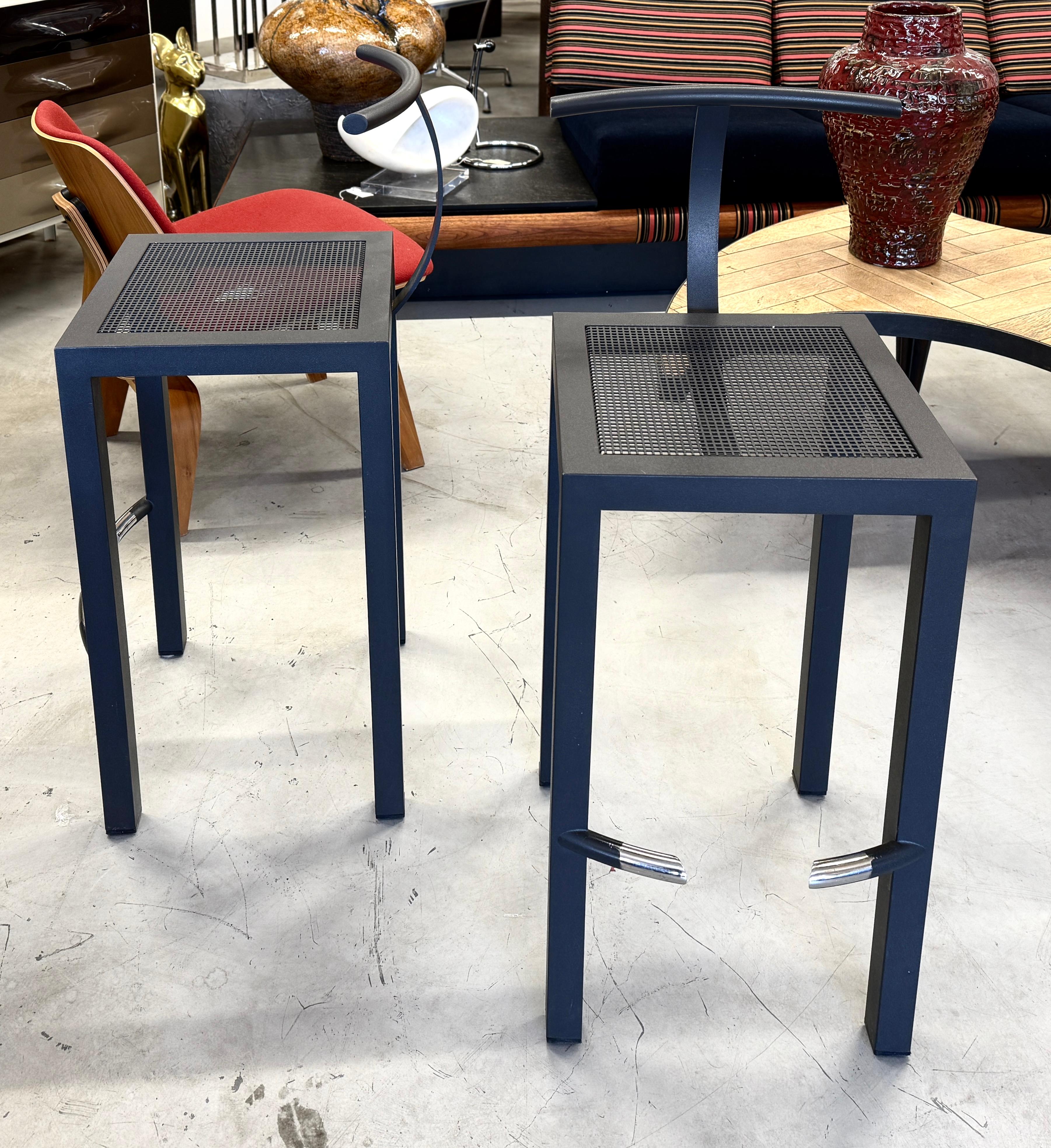 A set of 2 Driade steel Serapis stools designed Philippe Starck for his design firm Aleph Ubik. These are in very good overall condition with some minor paint loss on the foot rests, pictured.  These are surprisingly comfortable.
Seat height is