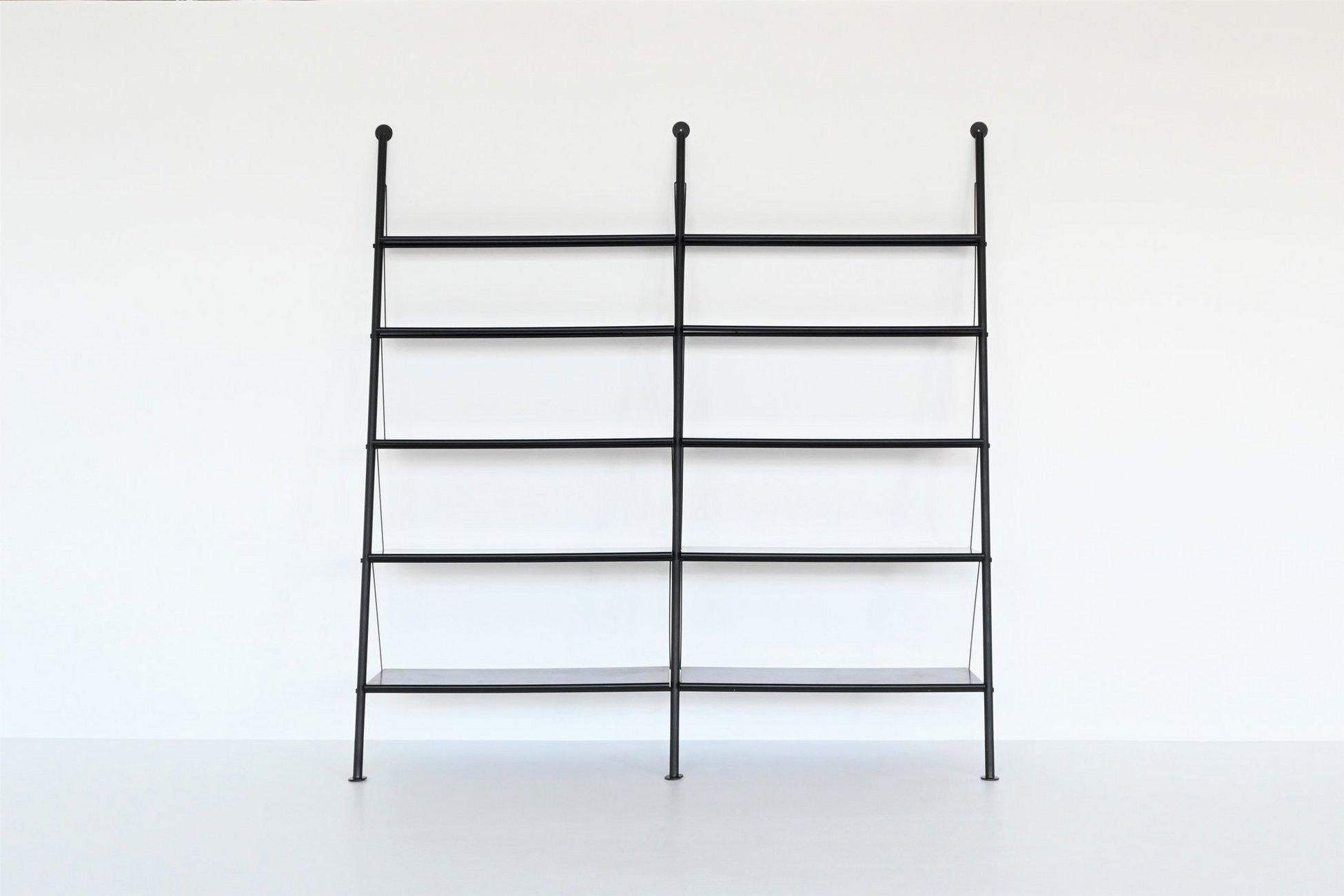 Beautiful and hard to find double shelving unit or bookcase model John Ild designed by Philippe Starck for Disform in Italy 1977. This very nice wall unit consists of three black coated tubular metal rods which supports ten black lacquered wooden