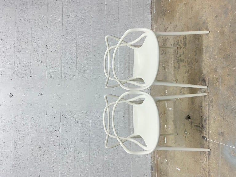 Pair of white masters chairs by Philippe Starck and Eugeni Quitllet for Kartell.

Philippe Starck and Eugeni Quitllet pay homage to three different midcentury-modern masters in one sleek, versatile indoor-outdoor seat. The Masters Chair (2010)