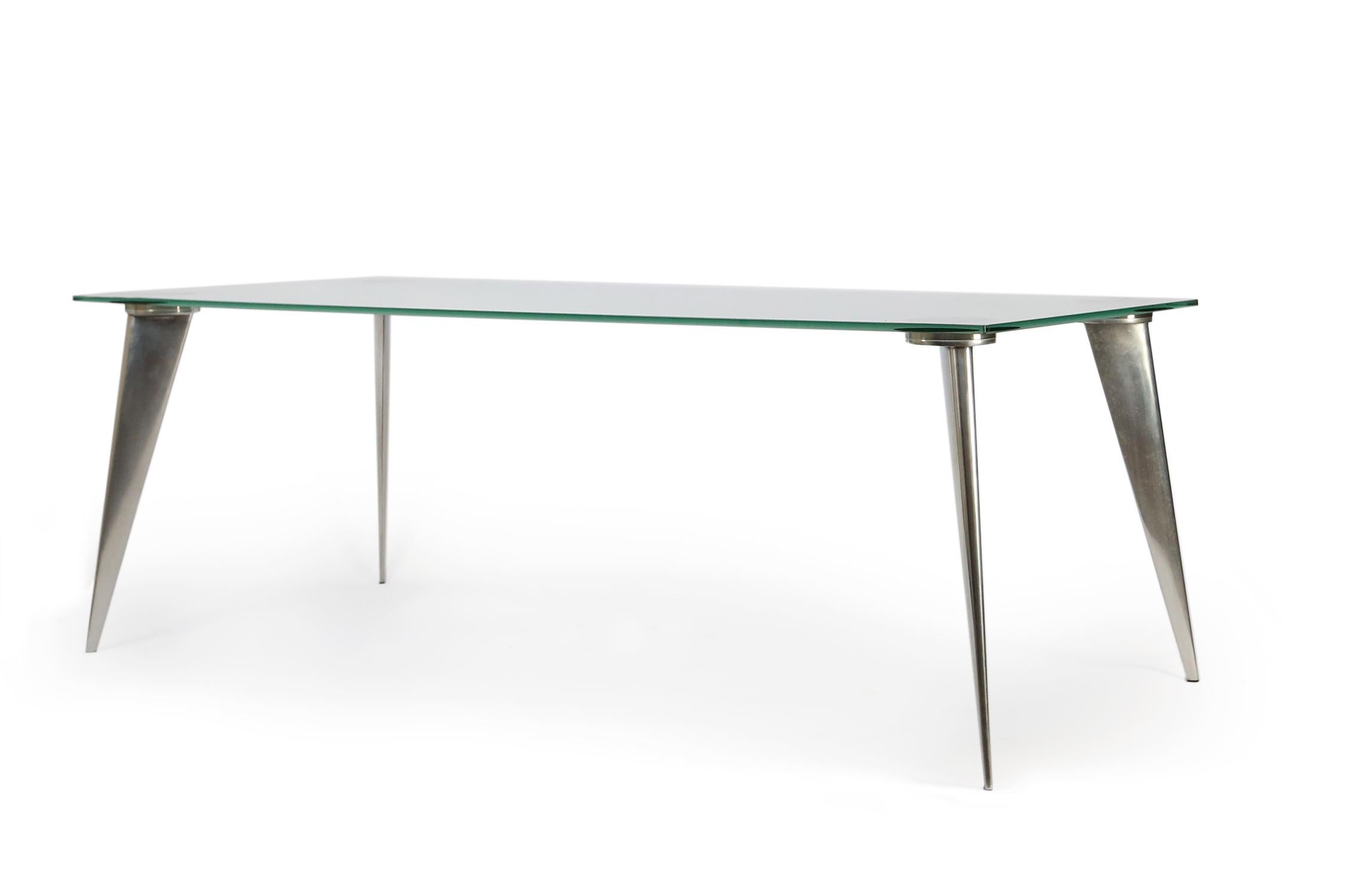 Vintage model M-dining table by Philippe Starck for Aleph
Rectangular glass table model resting on four chromed aluminum profiled legs. The glass is in absolute great condition no chips or scratches on the glass.

 
