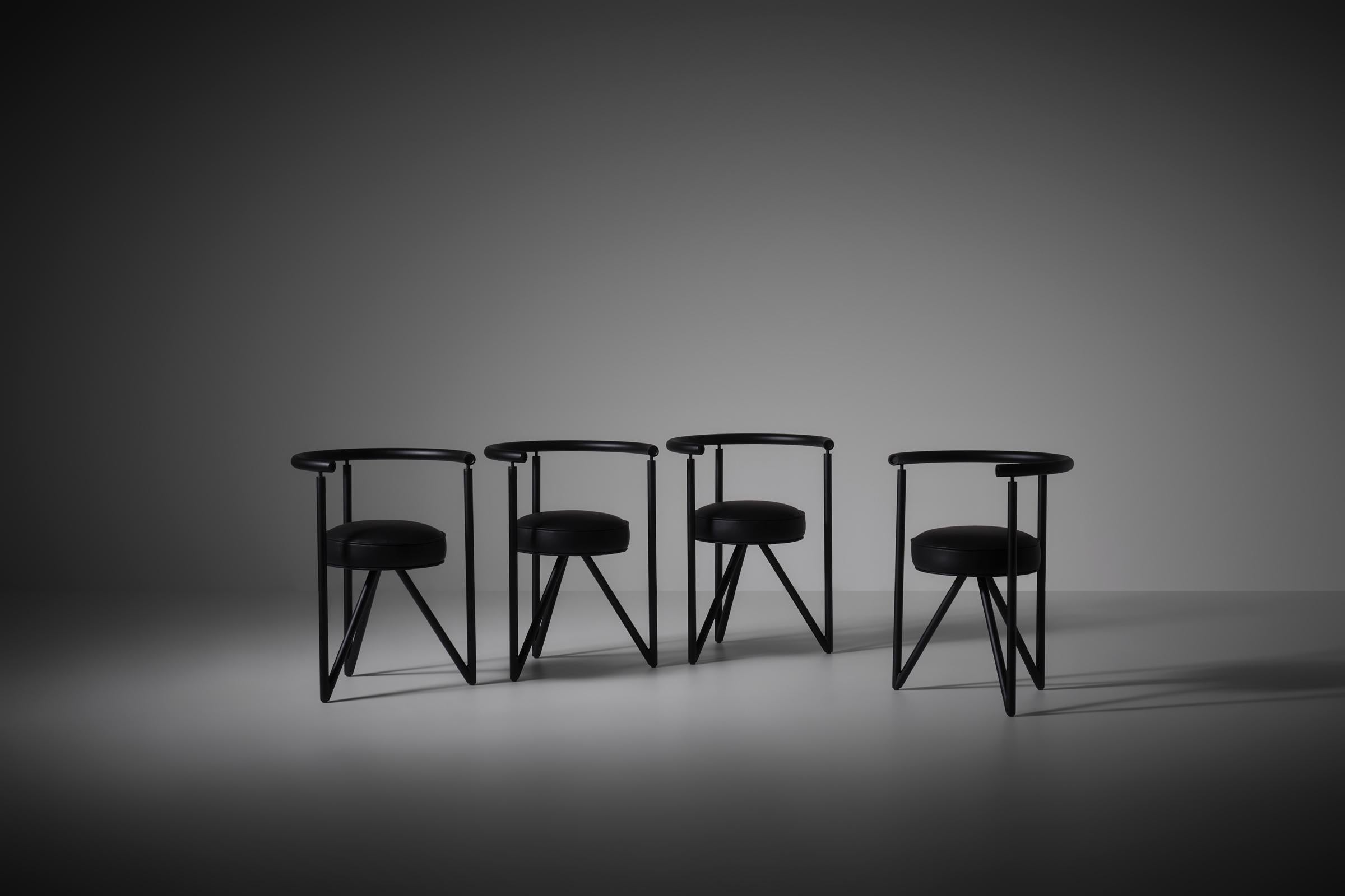 Miss Dorn chairs by Philippe Starck for Disform, 1982. Black coated tubular steel frames and round cylindrical black leather seats. The combination of their primary shapes and hard lines provide a very interesting sculptural silhouette to the