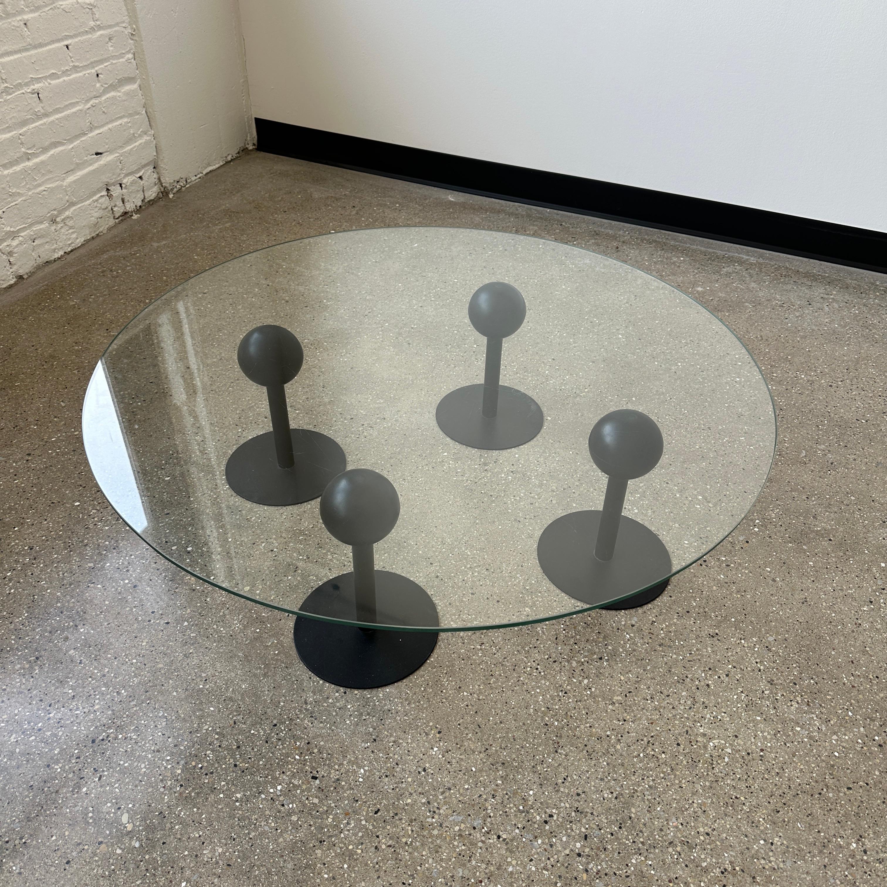 for Disform c. 1983, Spain. The four black supports feature rubber globes that gently cushion the glass - they can also be adjusted to fit any shape. This piece is in vintage condition with minimal wear. The glass has some scratches and scuffs but