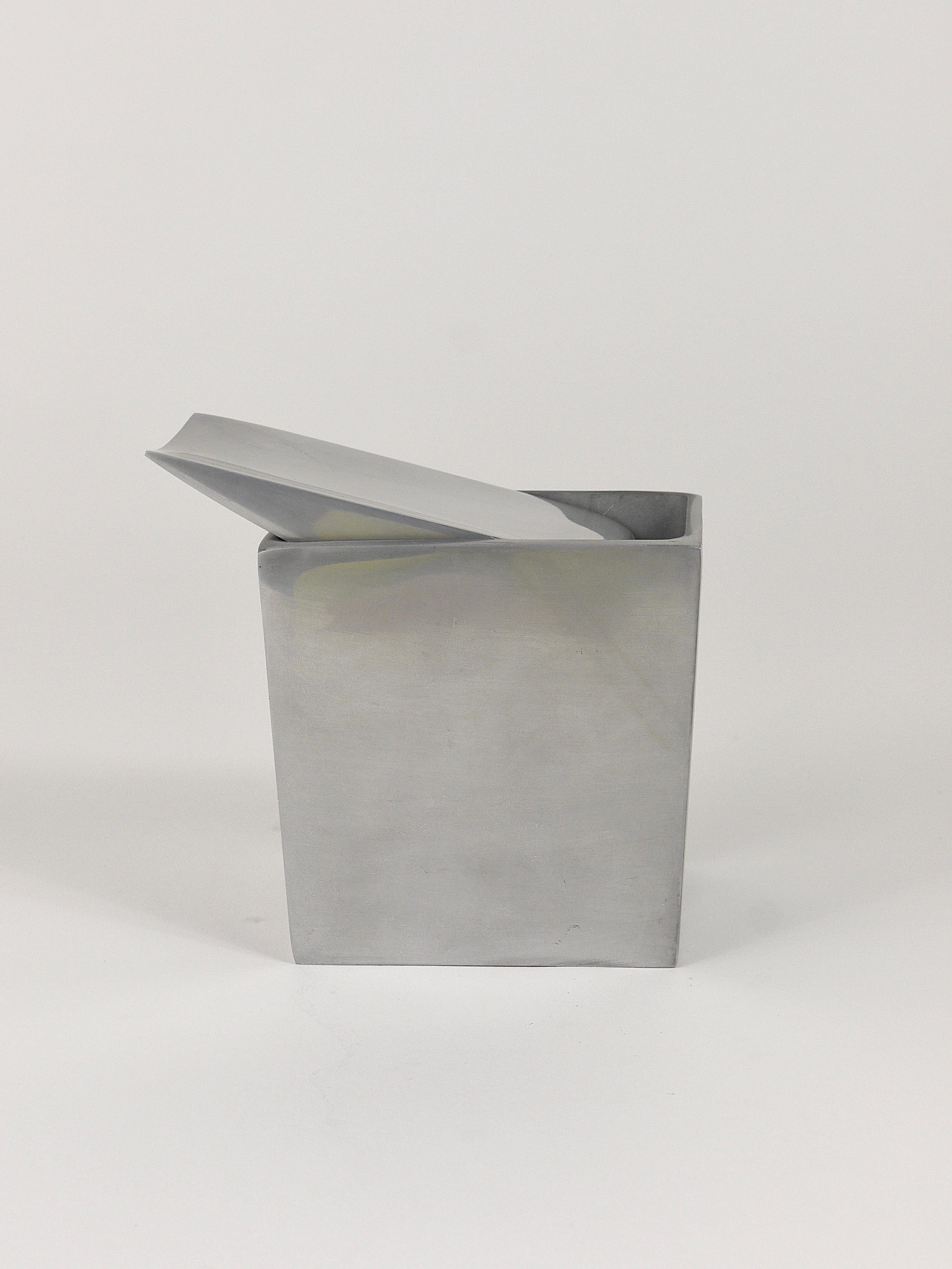 Iconic tilting wing ashtray designed in 1986 by Philippe Starck for the Royalton Hotel in New York. Executed by XO, France. 
Made of polished aluminum, signed on the inside of the lid. Part of the MoMA design collection. In good condition with