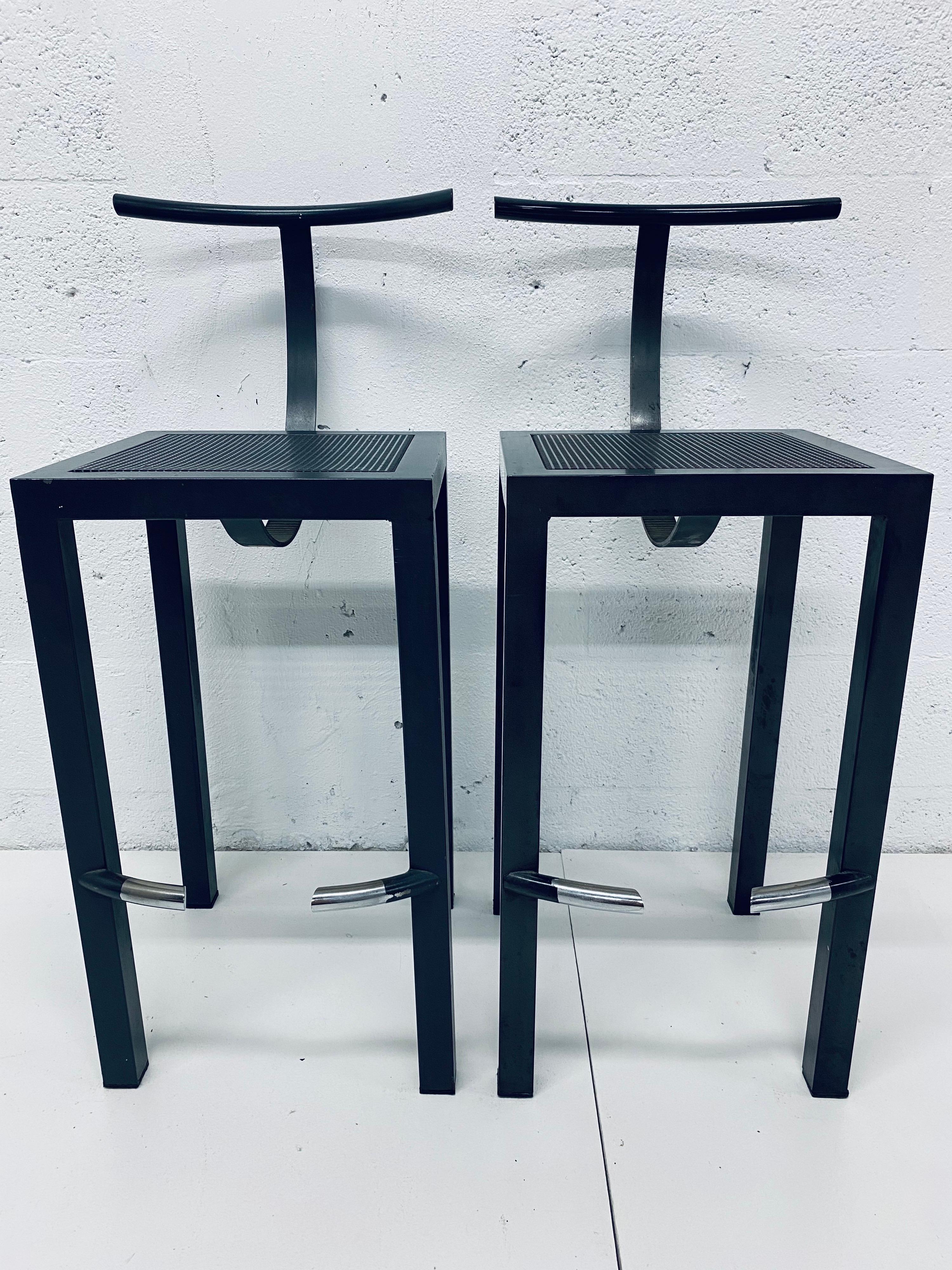 Pair of Postmodern black steel bar stools with perforated steel seats designed by Philippe Starck for his studio Aleph Ubik and manufactured by Driade, Italy, 1980s.