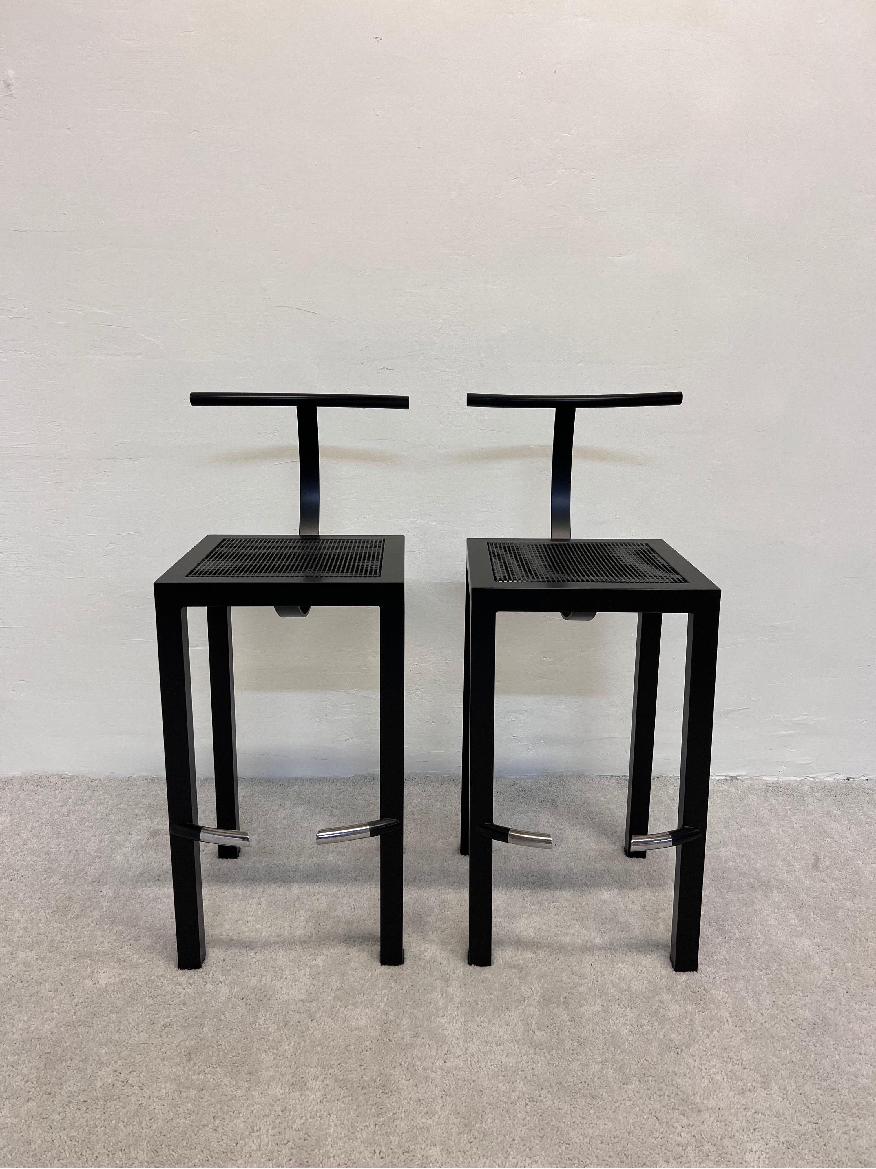 Pair of Postmodern satin black steel bar stools with perforated steel seats designed by Philippe Starck for his studio Aleph Ubik and manufactured by Driade, Italy, 1980s. Chairs have been professionally refinished in satin black.