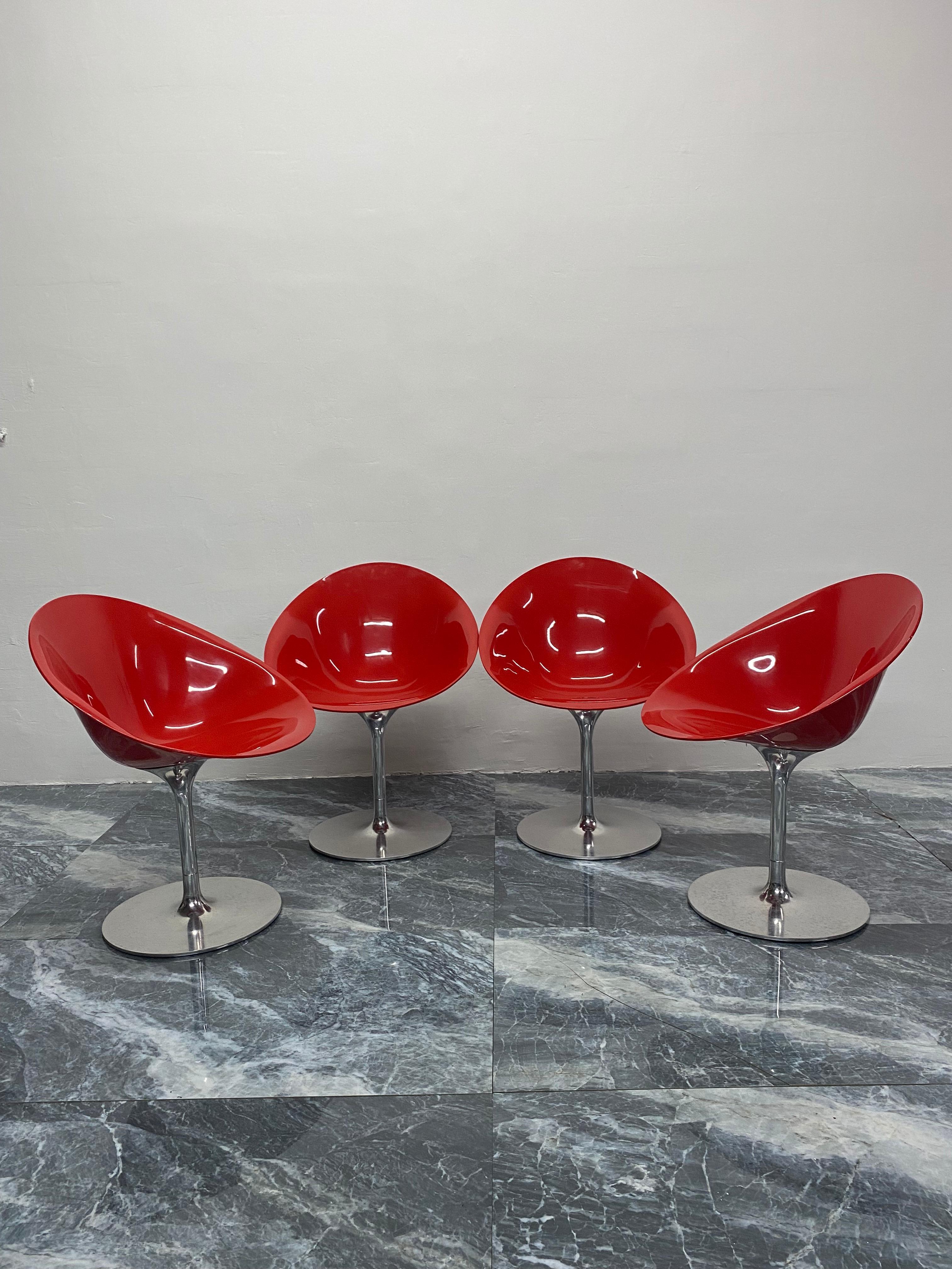 Glossy red polycarbonoate Eros chairs on aluminum trumpet swivel bases by Philippe Starck for Kartell. Made in Italy. The red polycarbonate seat is not transparent.

Available in sets of two.  Only one pair available.