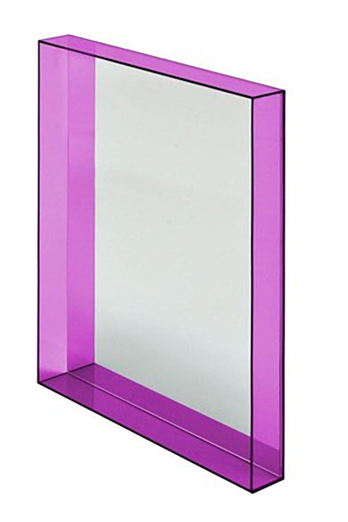 Rectangular wall mirror Mod. Only Me with a fuchsia resin frame that can be hung in either direction. The mirror was designed by Philiphe Starck for the Kartell Company.