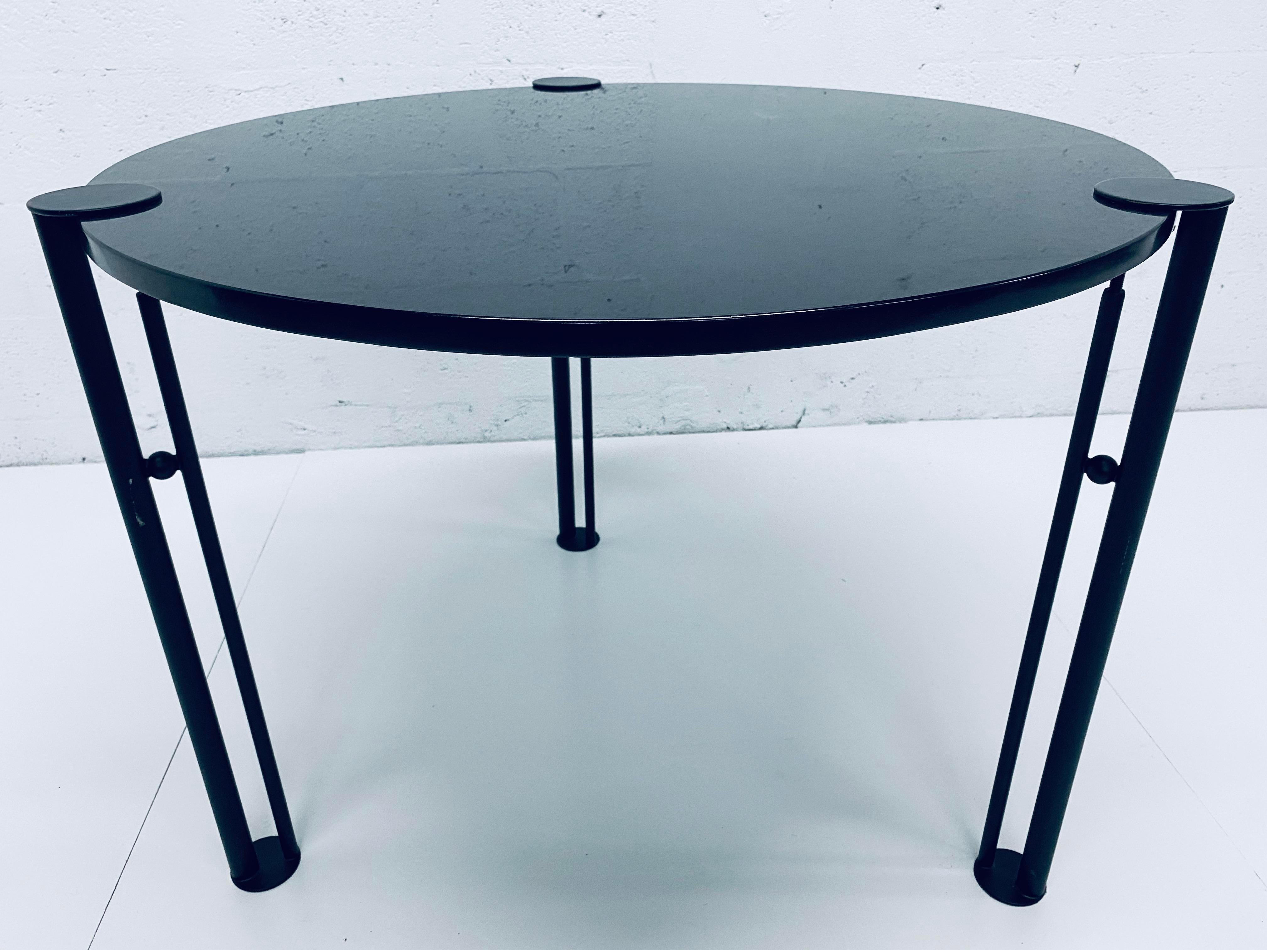 Black granite with black steel leg dining or center table from the 1980s and designed by Philippe Starck. The legs have clamps to hold to granite top. Made to be interchangeable.