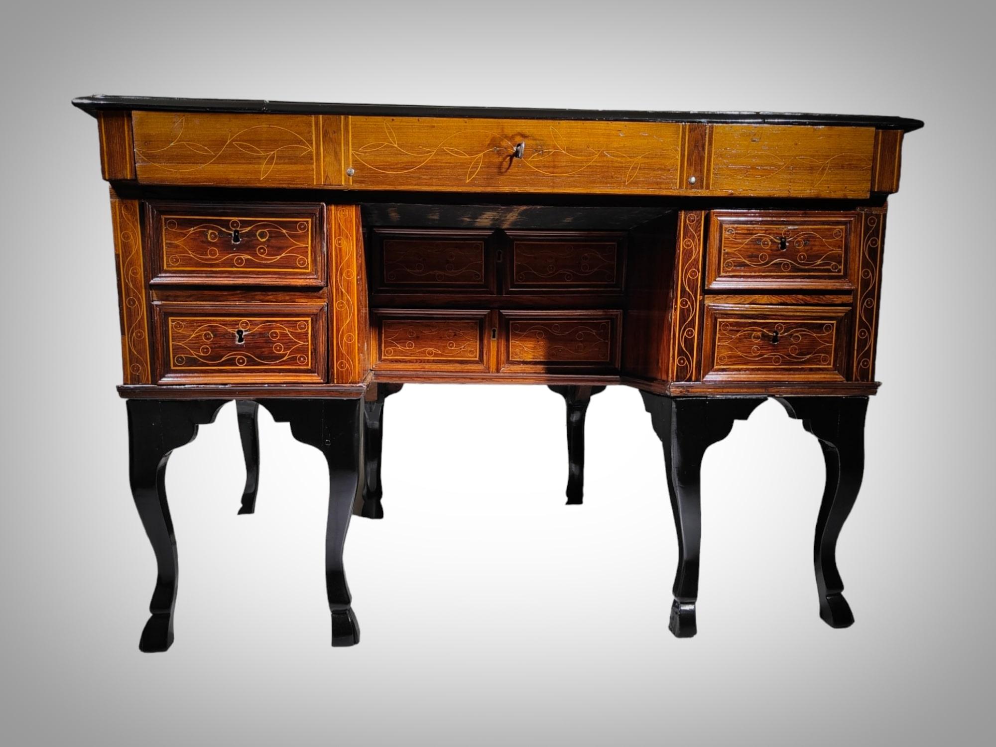 This exceptional Felipe V writing desk is a true masterpiece of cabinetmaking. It captivates with its graceful design and meticulous craftsmanship. The piece, with a hinged cover and front, has been fashioned from the rich and warm woods of walnut