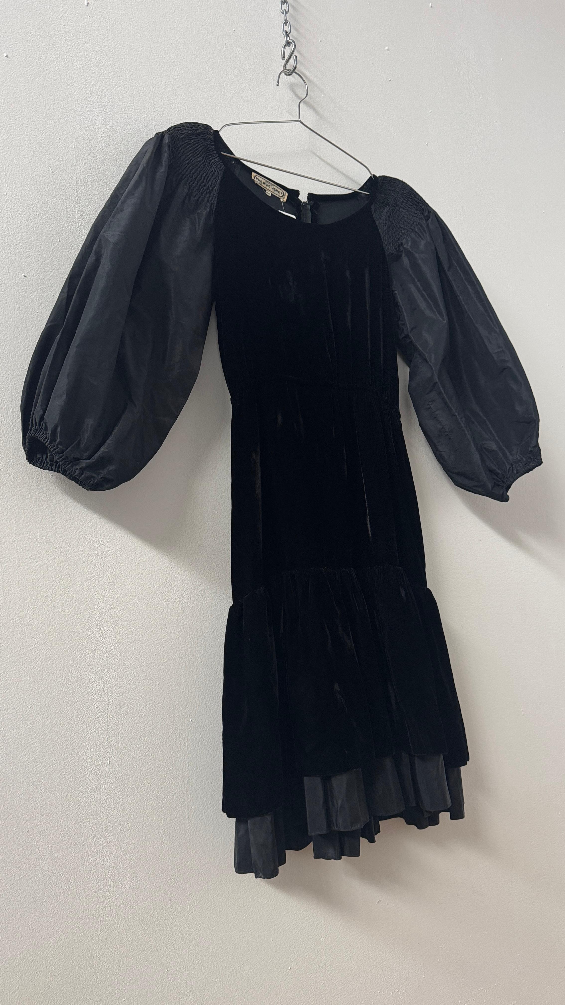 Step into timeless elegance with this rare vintage dress by legendary French couturier Philippe Venet, known for his refined, discreet luxury and masterful tailoring.

Crafted in the late 1970s, this striking black dress showcases a rich velvet