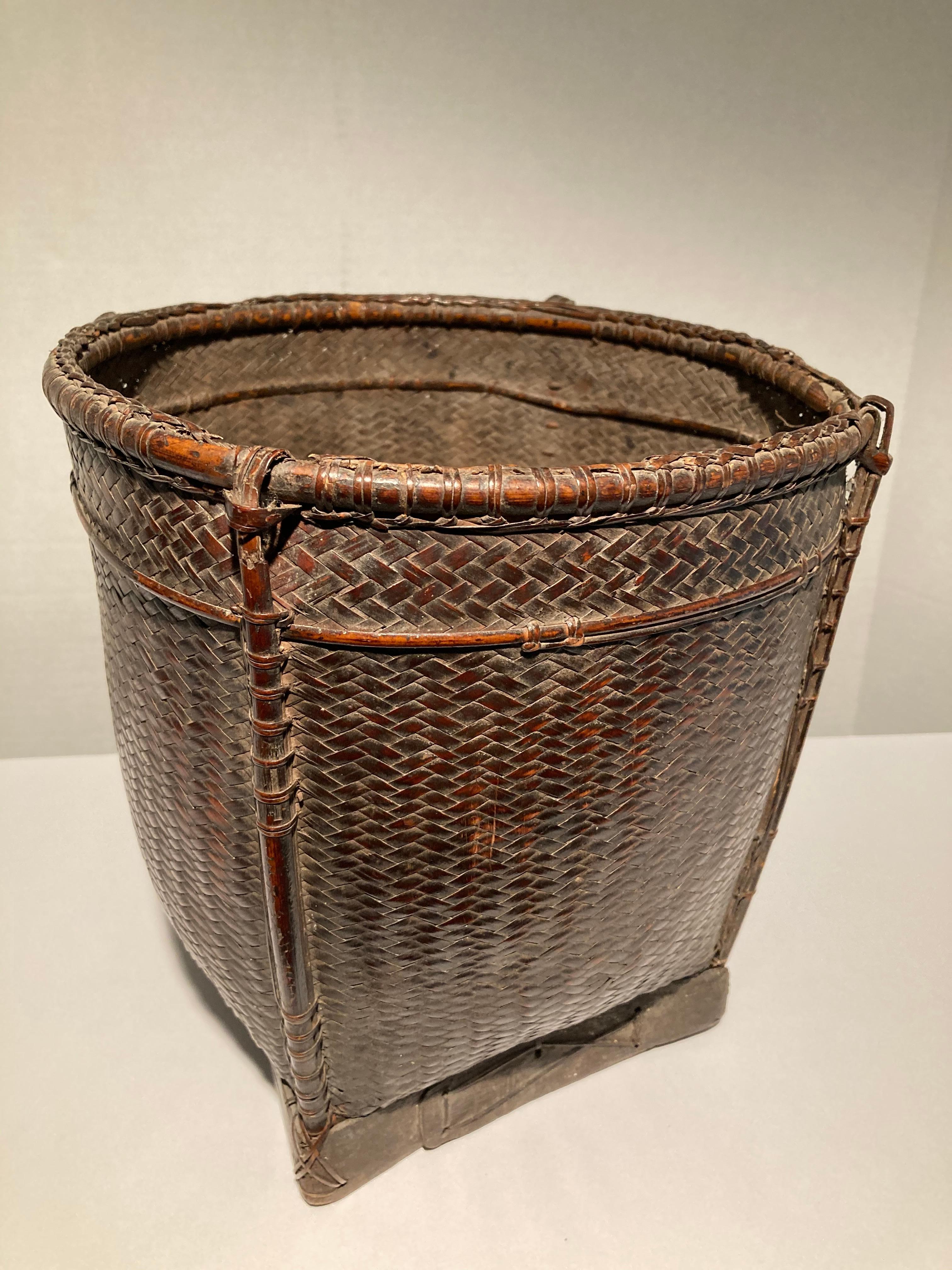 Woven rattan storage basket from the Palawan Islands of the westernmost Philippines. Excellent patina, superb quality and condition. From the collection of a retiree ship's captain who traveled regularly to the Philippines for over 40 years.