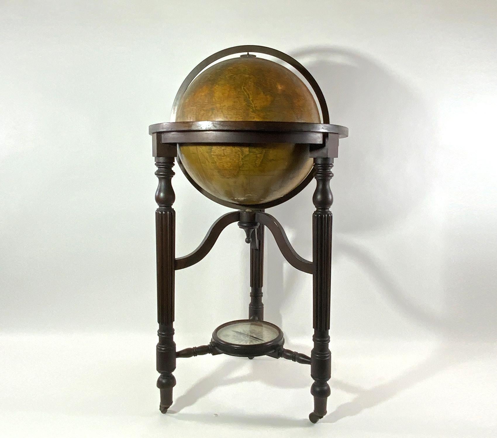 Rare library globe by Philipps Fleet Street. Late 19th century. Mounted on a mahogany stand with three receded and turned legs and castors. Base has a working compass. Globe itself shows areas of wear and discoloration with some loss. 45