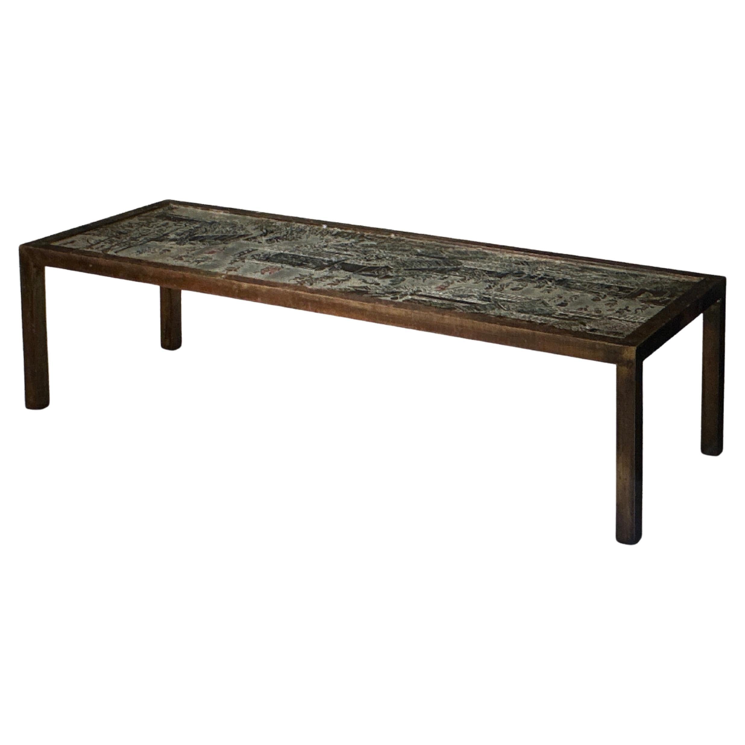 This is an acid-etched , enameled and patinated bronze and pewter cocktail table signed by Philip and Kelvin Laverne known as the Chan-Li Low Table.  It  was made in the 1970' by the father son team using a proprietary method to etch the bronze and