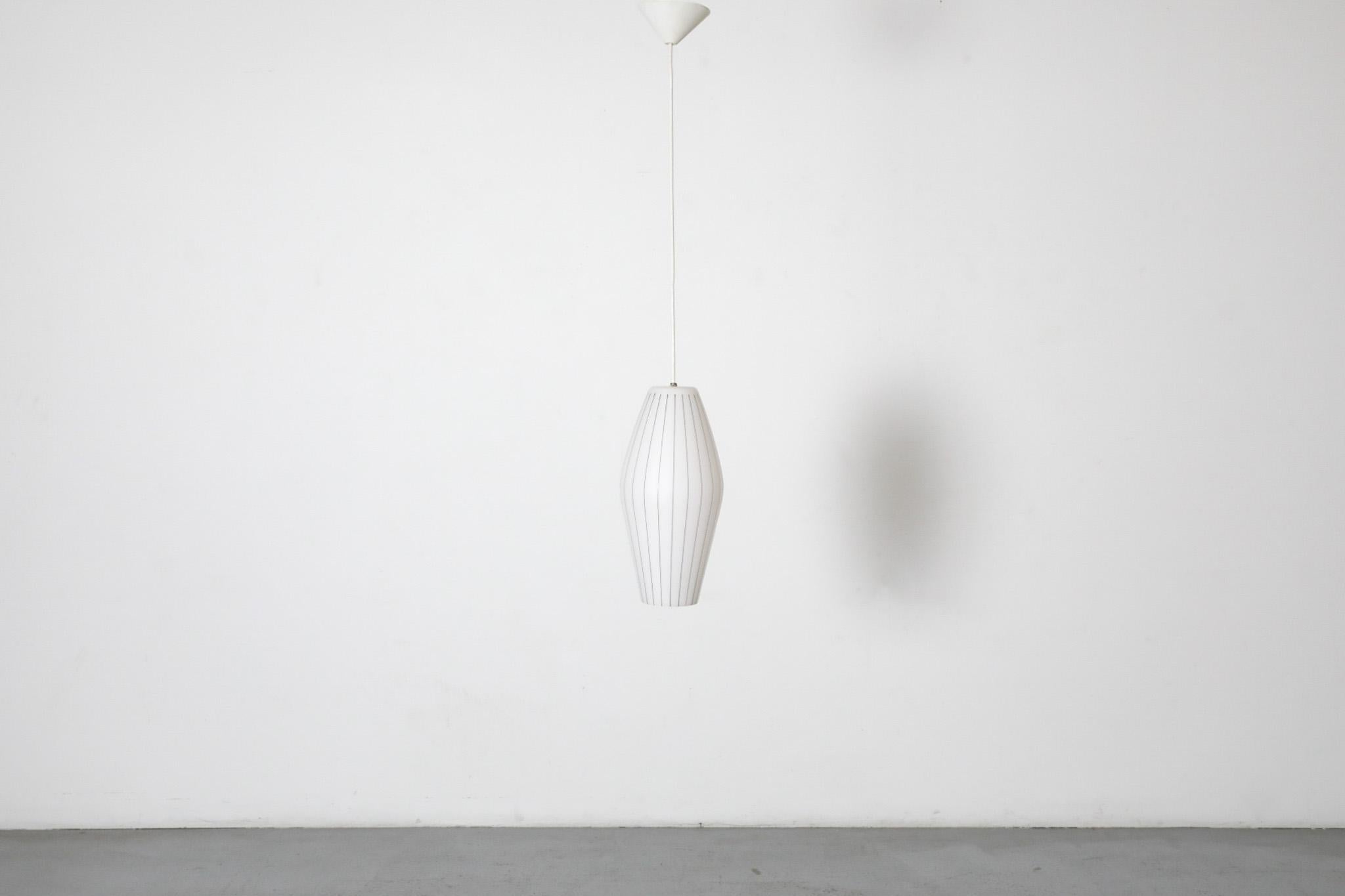 Philips milk glass mold blown pendant with decorative thin black stripes. In original condition with standard sized medium base socket and white plastic canopy. Minimal blemishes consistent with its age and some regular. Pendant height: 15