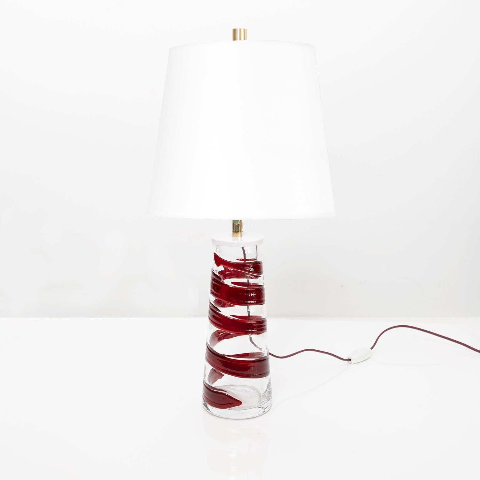 Philips Midcentury clear glass table lamp with spiral band of red glass. Newly re-wired with a single 3-way socket in lightly patinated harp and finial. Shade not included.

Total height: 22.25” body height: 10.5” Diameter: 4.5.