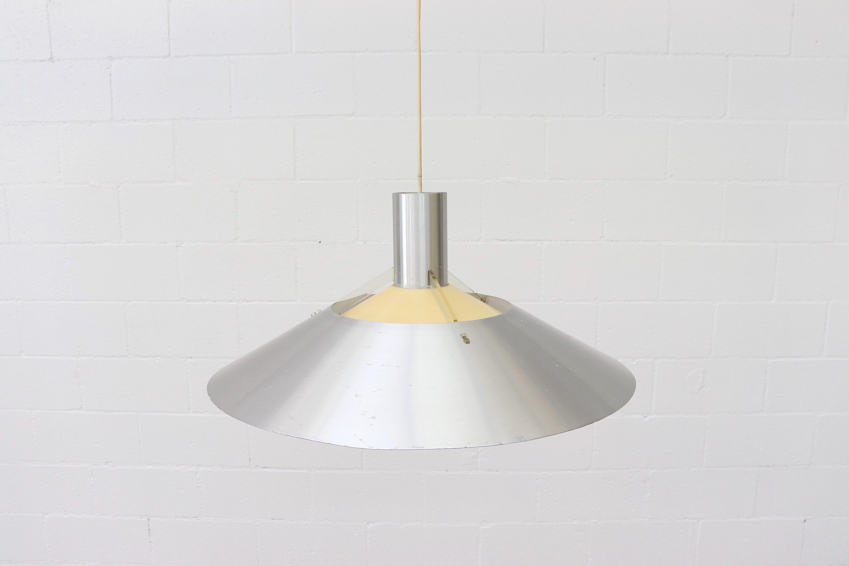 Handsome Bent Boysen designed UFO pendant light with spun aluminum shade and diffuser as well as clear plexiglass hardware holding second yellow Plexi accent shade. Cord is approximately 24
