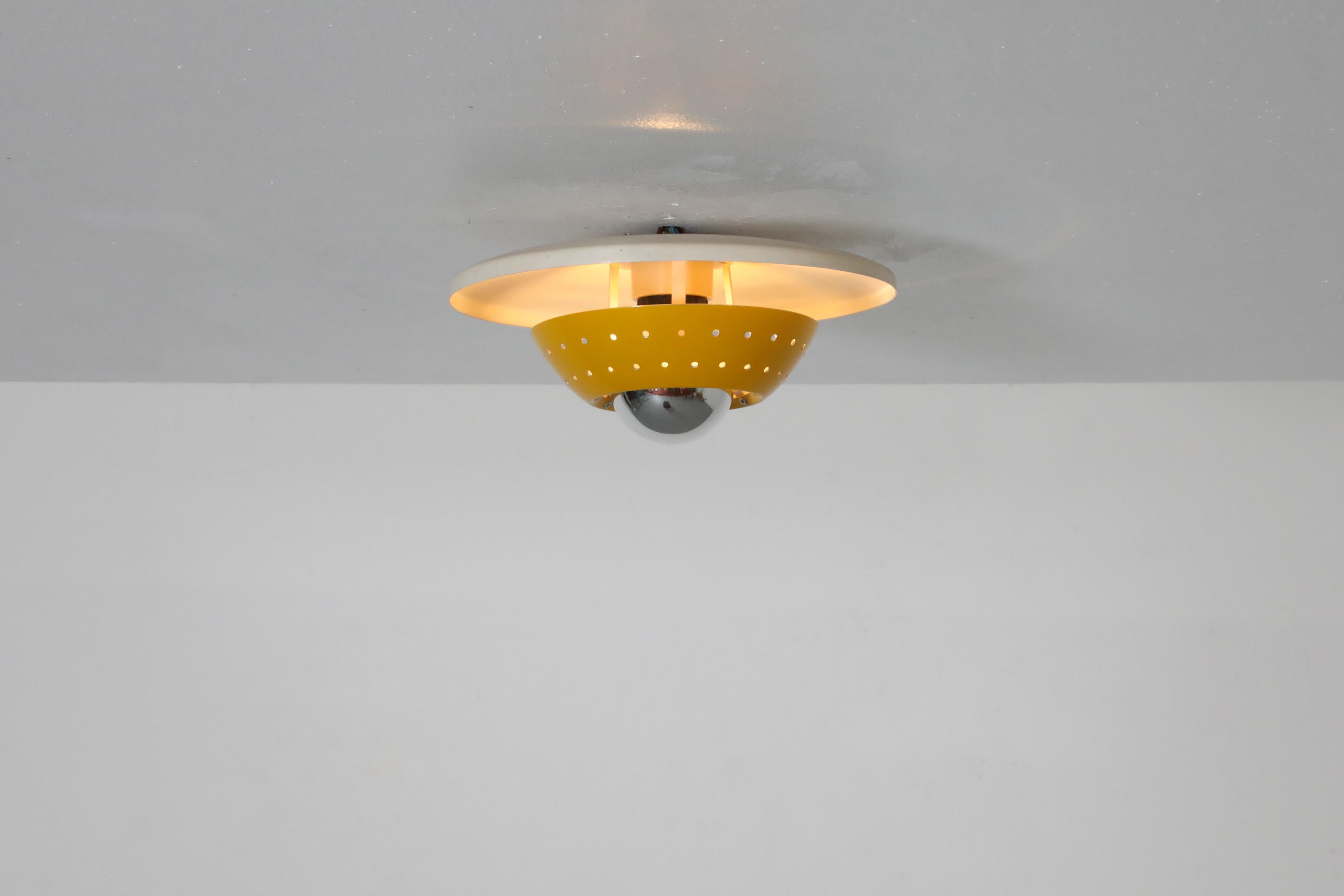 Mid-Century Modern Philips Style Perforated Yellow Enameled Metal Ceiling Lamp For Sale