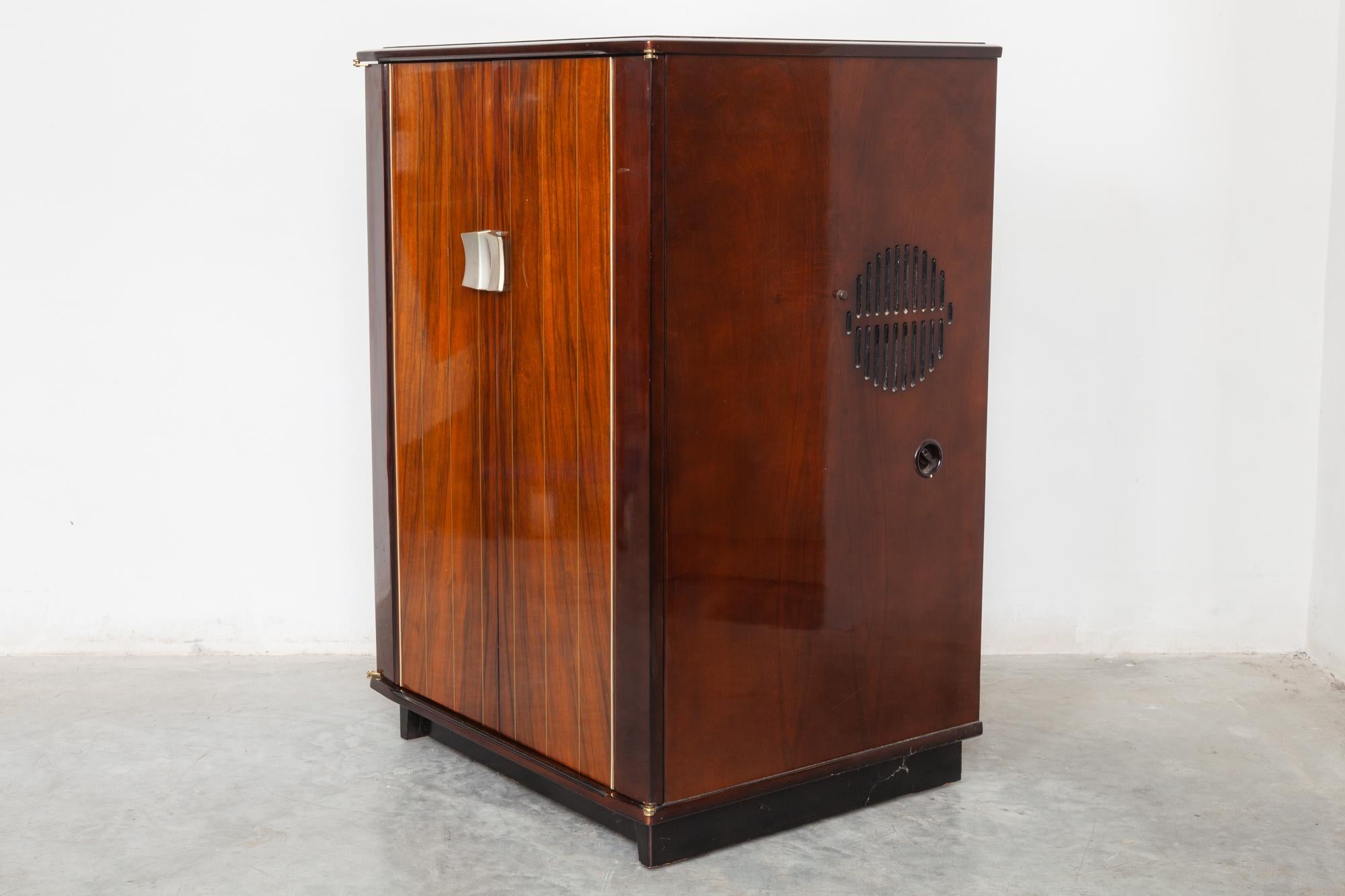 Original 1958 TV cabinet designed by Philips

Vintage midcentury cabinet with television and Radio by Phillips. The fantastic design of glossy wood doors that open to reveal a pristine gold details the furniture is designed by DeCoene.
Complete