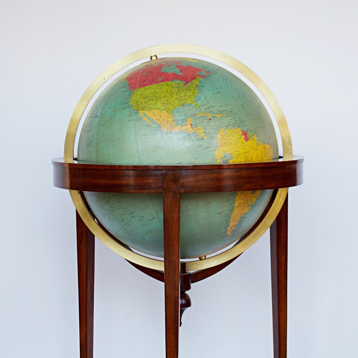 A late 18th century style terrestrial globe printed and manufactured by George Philip & Son Ltd. mahogany and walnut stand, with a paper glass covered compass underneath.

Dimensions: H 106 cm, D 60 cm

Origin: English

Date: circa