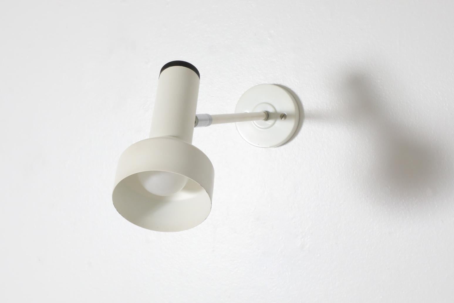 Mid-Century, 1970's white enameled wall or ceiling mount spotlights by Philips, attributed to Louis Kalff. Kalff was the main designer for Philips for the majority of the post-war era.  These mod spotlights are outfitted with a black dial for