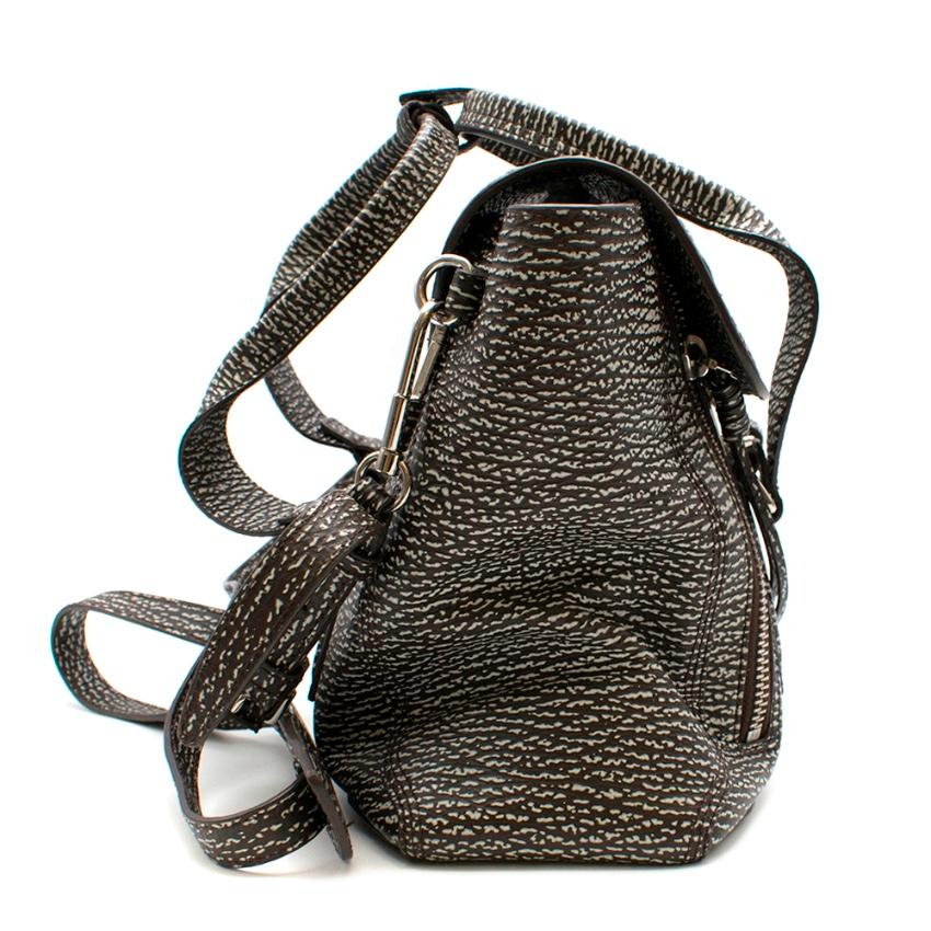 Phillip Lim Two-Toned Medium Pashli Satchel 

The Pashli satchel in a compact medium size, featuring a unique brown & white shark-embossed print. The double top handles create ladylike polish contrasted against zipper gussets that unzip into a fan