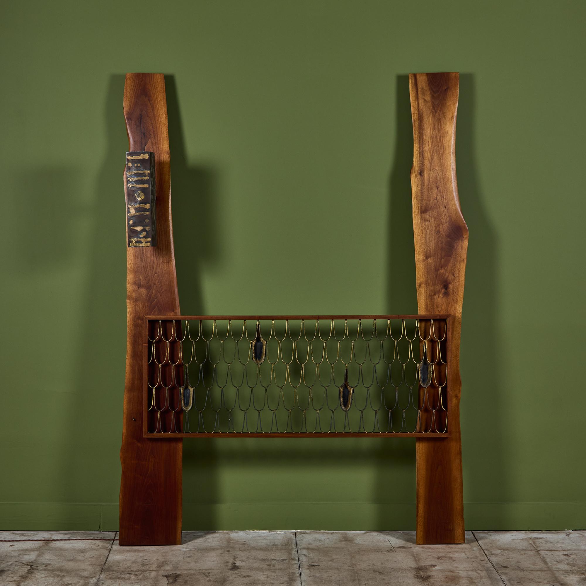 Queen size headboard by American designers Phillip Lloyd Powell and Paul Evans c.1960s, USA. The headboard features two live edge walnut vertical planks with the famous Paul Evans gilt iron fish scale screen headboard. This piece also showcases a