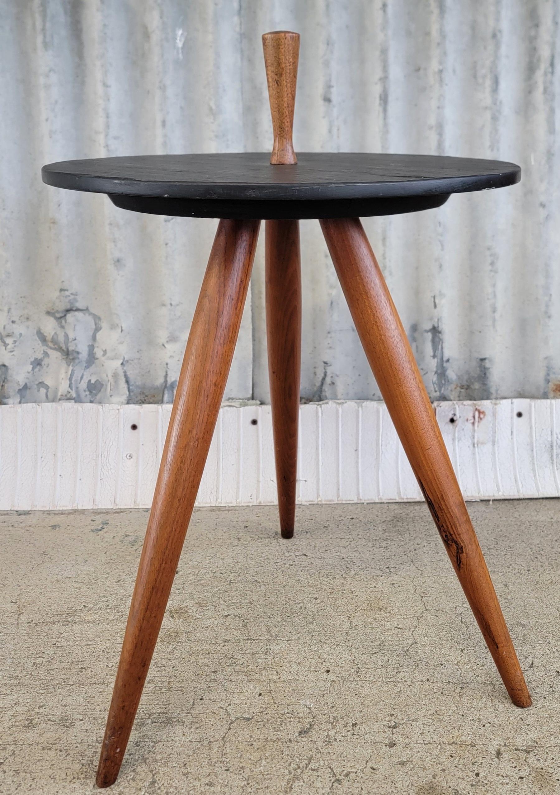 A Mid-Century Modern tripod side table made of slate with solid walnut peg legs and handle. Attributed to Phillip Lloyd Powell as there are no labels to confirm. Fine craftsmanship and materials. Table measures 21.75 inches to top of handle, slate