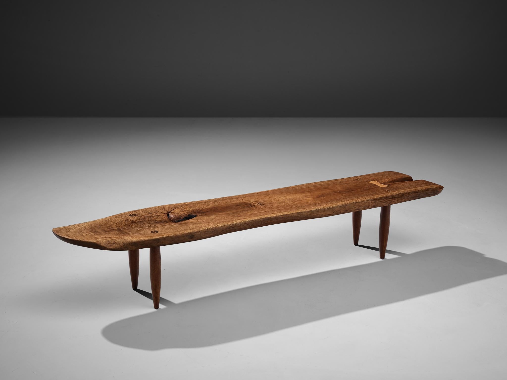 Phillip Lloyd Powell, coffee table, walnut, United States, 1960s

Stunning coffee table with free edges by US designer Phillip Lloyd Powell. On four circular tapered legs Powell places a long tabletop that follows the characteristics of the natural