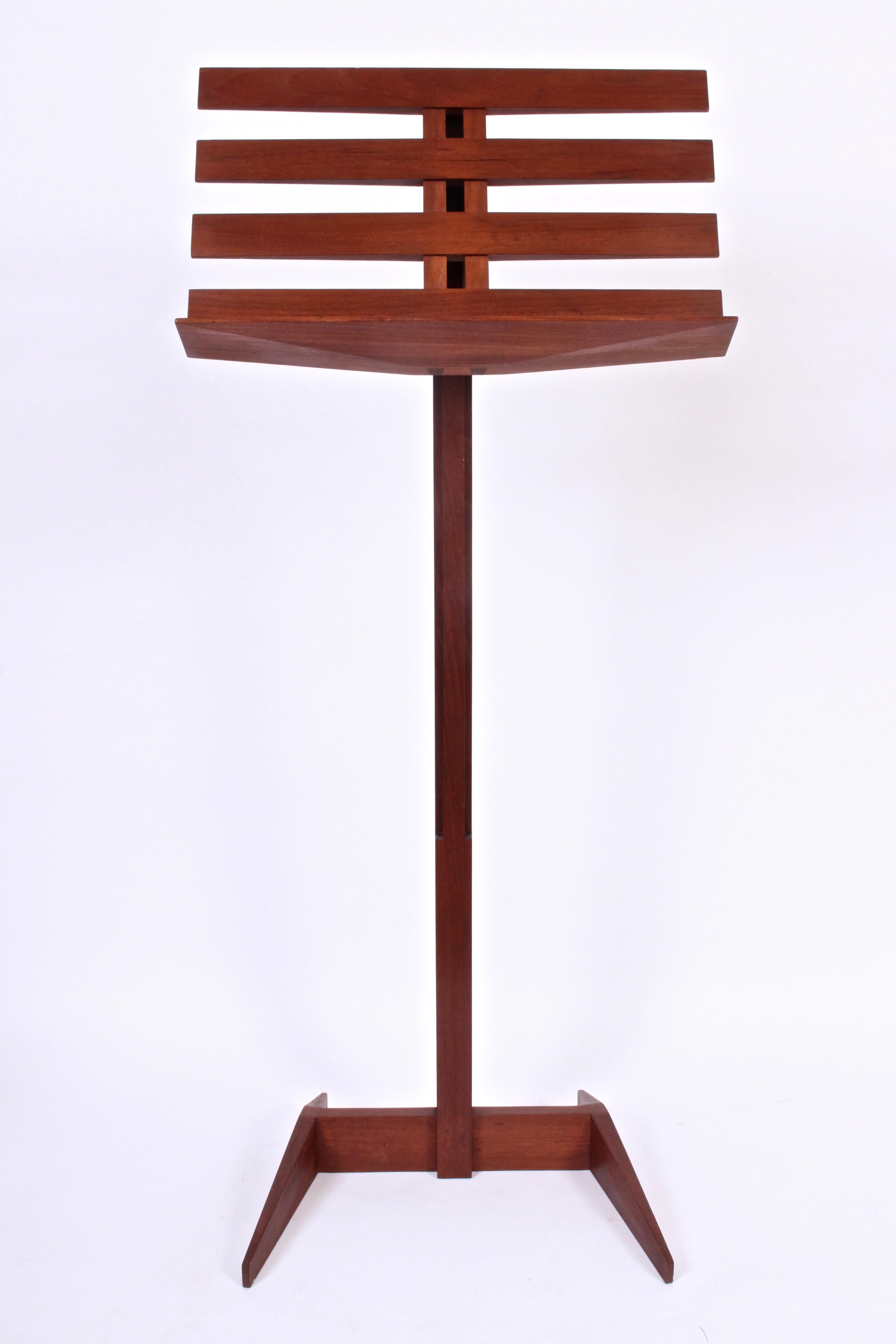 American New Hope School adjustable music stand, easel attributed Phillip Lloyd Powell, circa 1970. Featuring a smooth Walnut framework, handcrafted dovetail joints and functional brass knob. With adjustable shelf - lowers to 26 H.  Additional