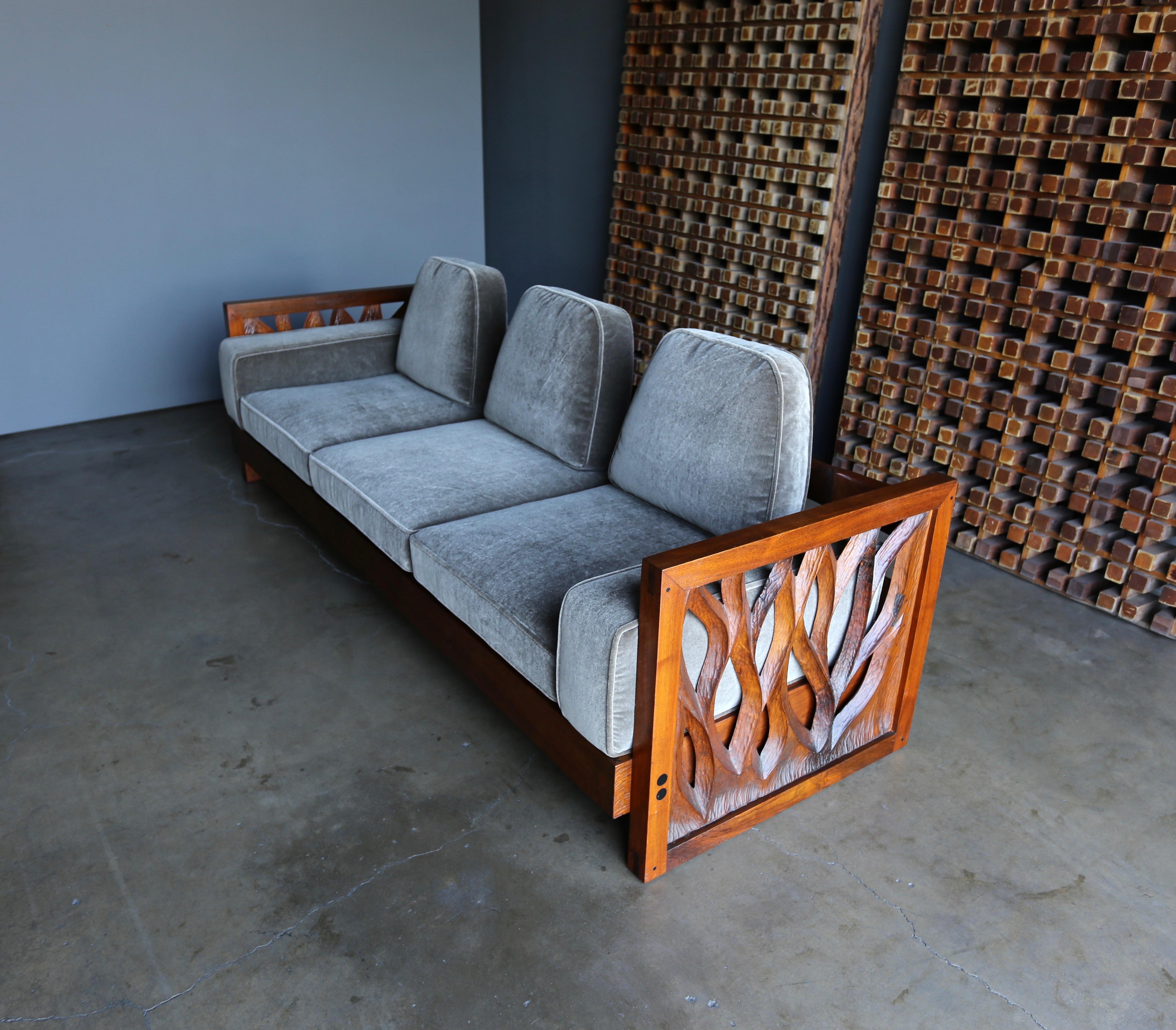 Phillip Lloyd Powell hand carved American black walnut sofa, circa 1969. 

New mohair upholstery.