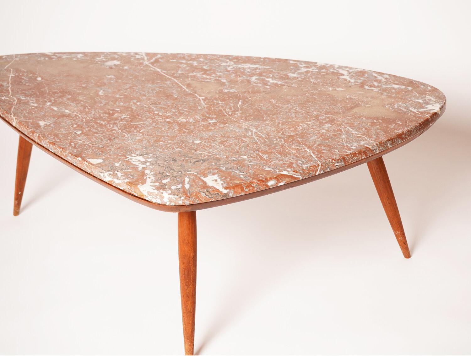 This Phillip Lloyd Powell marble coffee table features clean lines and a unique warm tone marble top. Born in Pennsylvania, Powell was known for his elegant and sculptural pieces. This table with a marble top is harder to find compared to his all