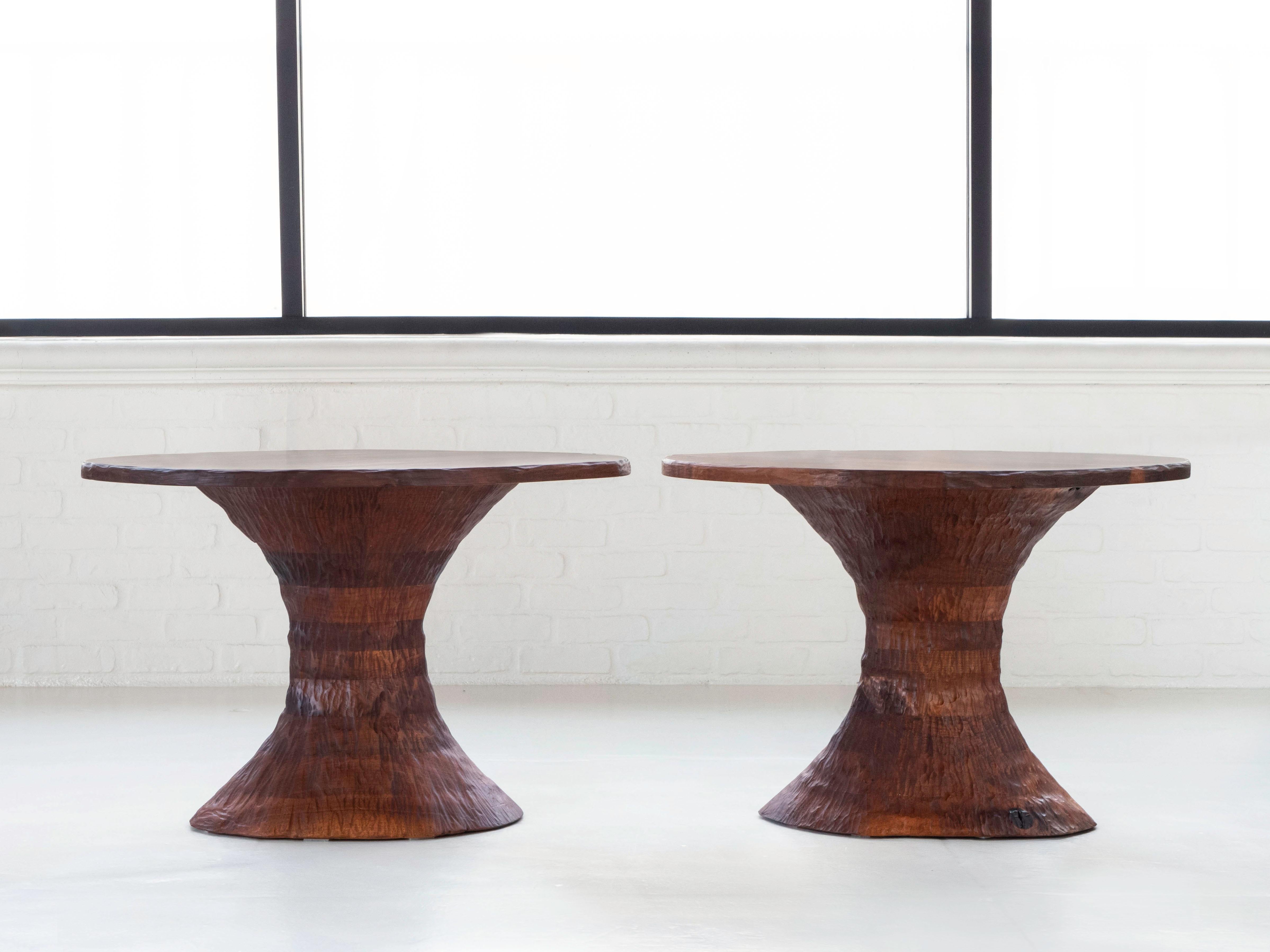 This pair of side tables were crafted by Phillip Lloyd Powell, circa 1960's. It is likely that the tables were commissioned as mates showing relatively similar shape and dimensions. The surfaces of both tables have book matched grain and each have 4