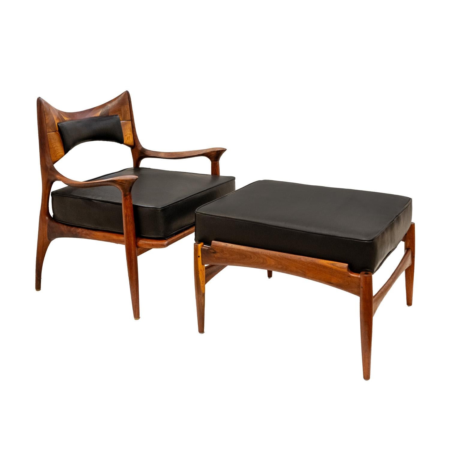 Iconic and rare chair and ottoman in sculpted walnut with black leather seat and inset leather backrest by Phillip Lloyd Powell, American early-1960s.  The craftsmanship of this chair and ottoman is superb.  Newly refinished and reupholstered in