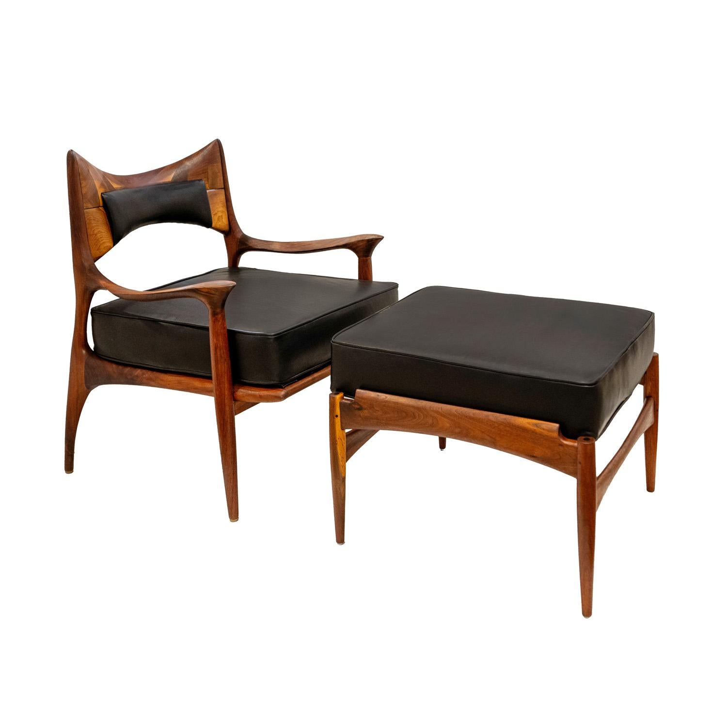 Iconic and rare chair and ottoman in sculpted walnut with black leather seat and inset leather backrest by Phillip Lloyd Powell, American early-1960s.  The craftsmanship of this chair and ottoman is superb.  Newly refinished and reupholstered in