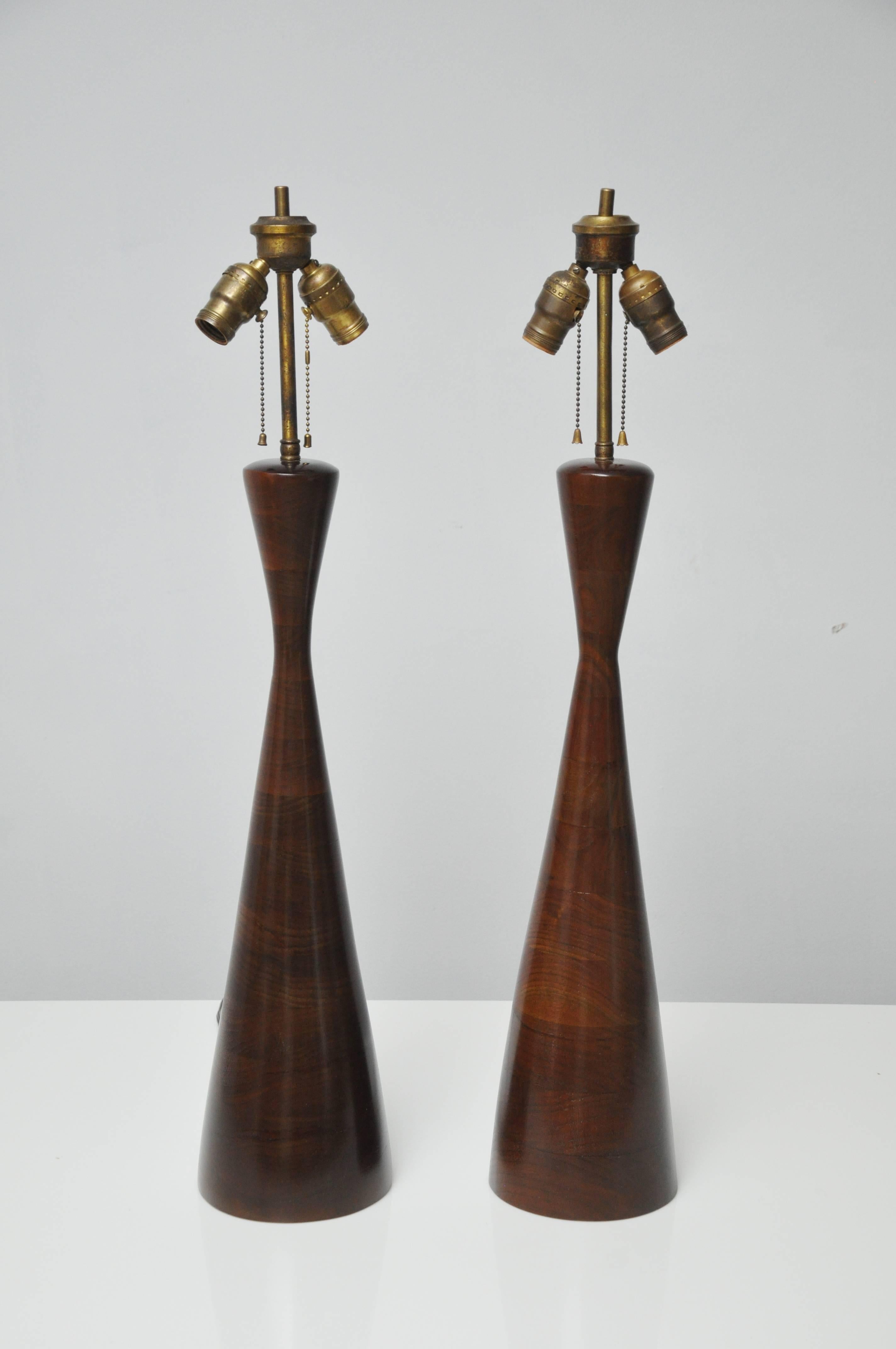 Iconic pair of Phillip Lloyd Powell stacked walnut lamps. Lamps have been refinished and have new shades.