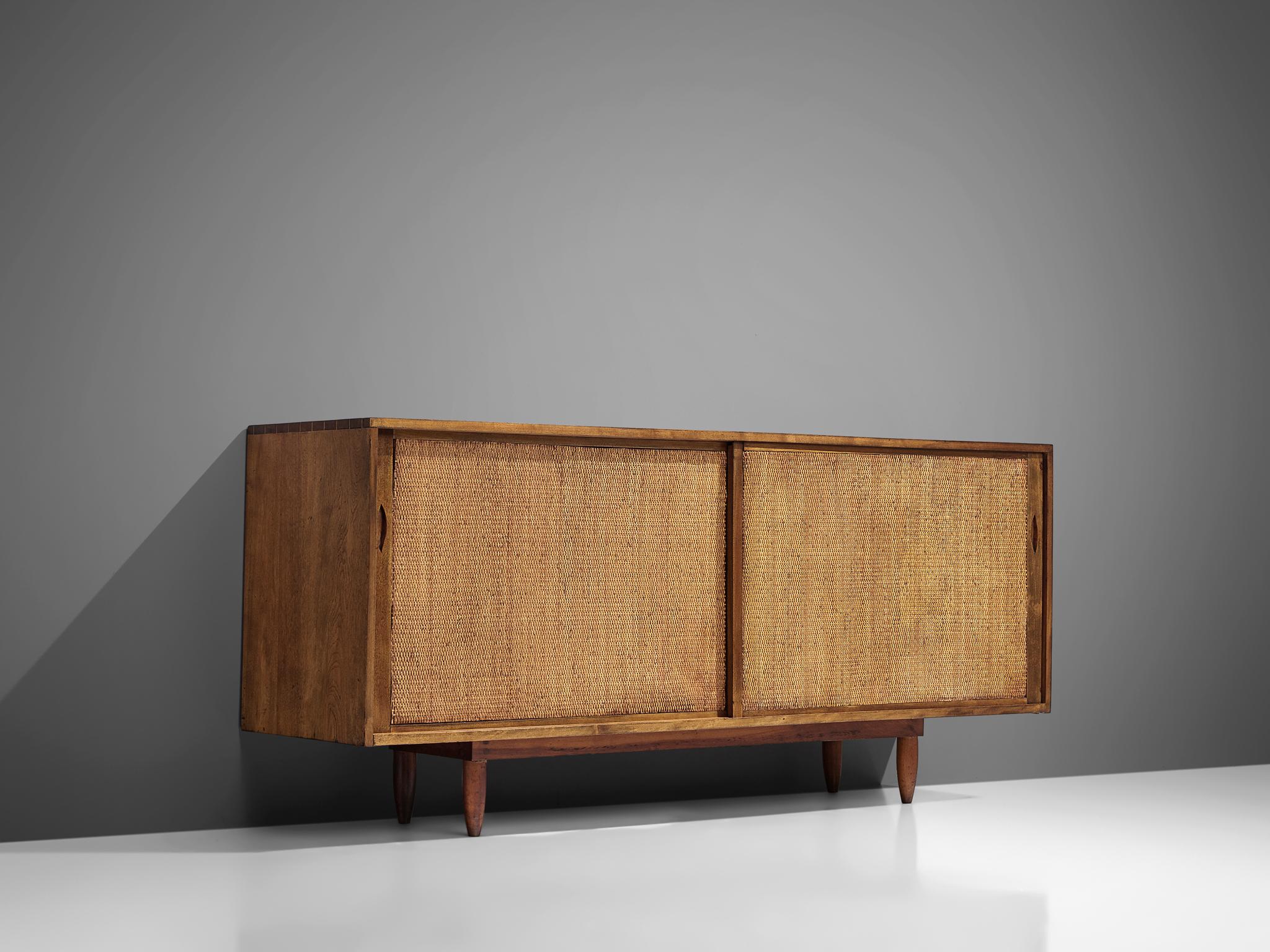 Phillip Lloyd Powell, sideboard, American walnut and grass-cloth, United States, circa 1960

This sideboard is designed and made by Phillip Lloyd Powell. The credenza is made out of solid walnut and the sliding doors are covered with grass-cloth.